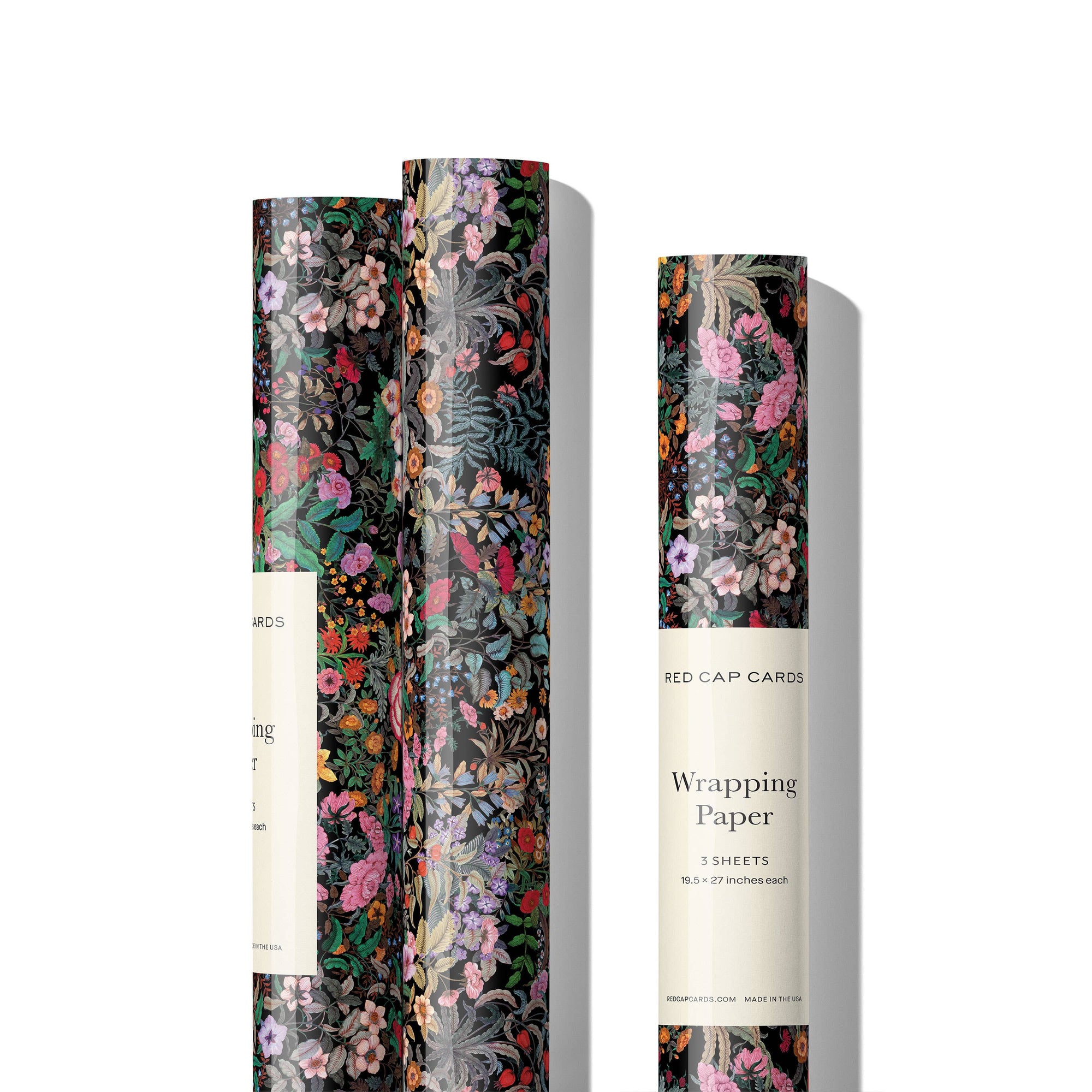 Roll of floral wrapping paper with a Red Cap Cards label on a white background