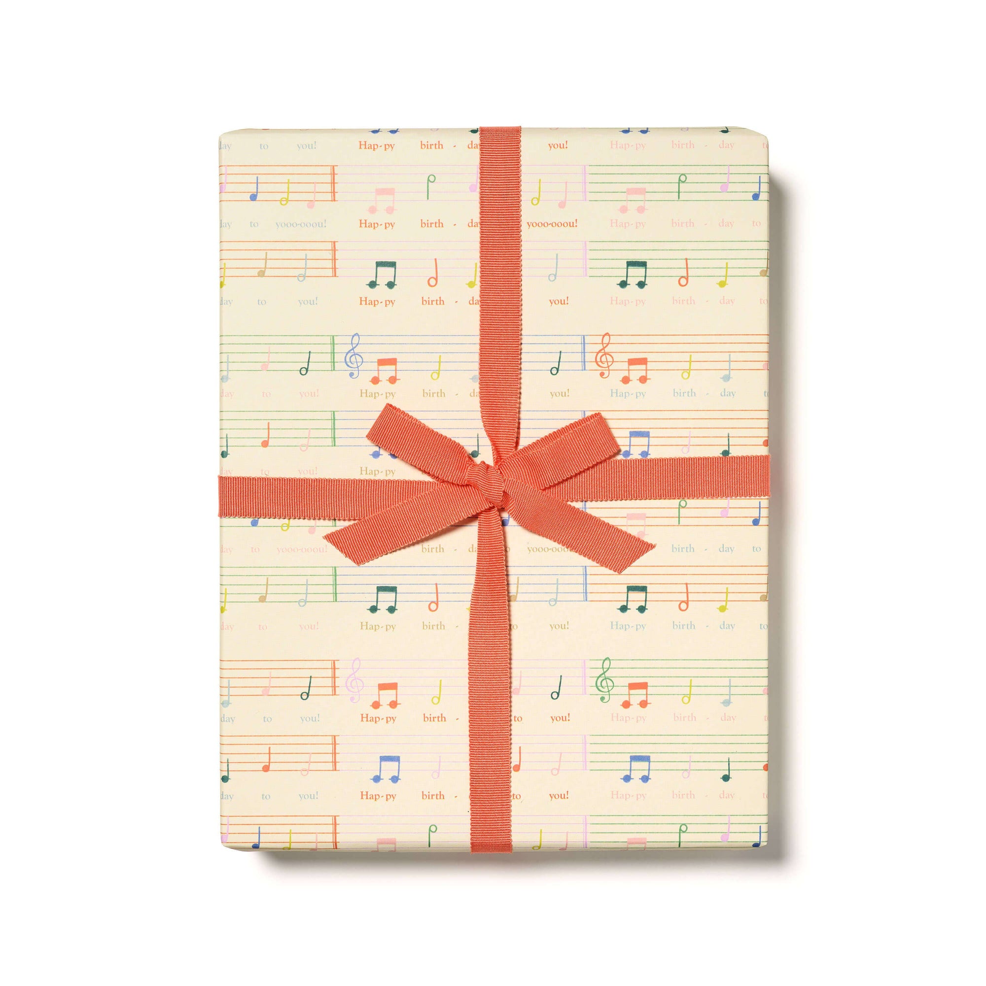 Gift box with musical notes pattern and red ribbon on a white background