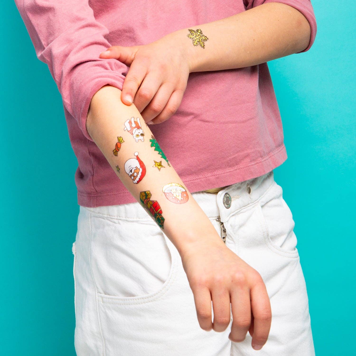 Child with colorful temporary tattoos on a turquoise background
