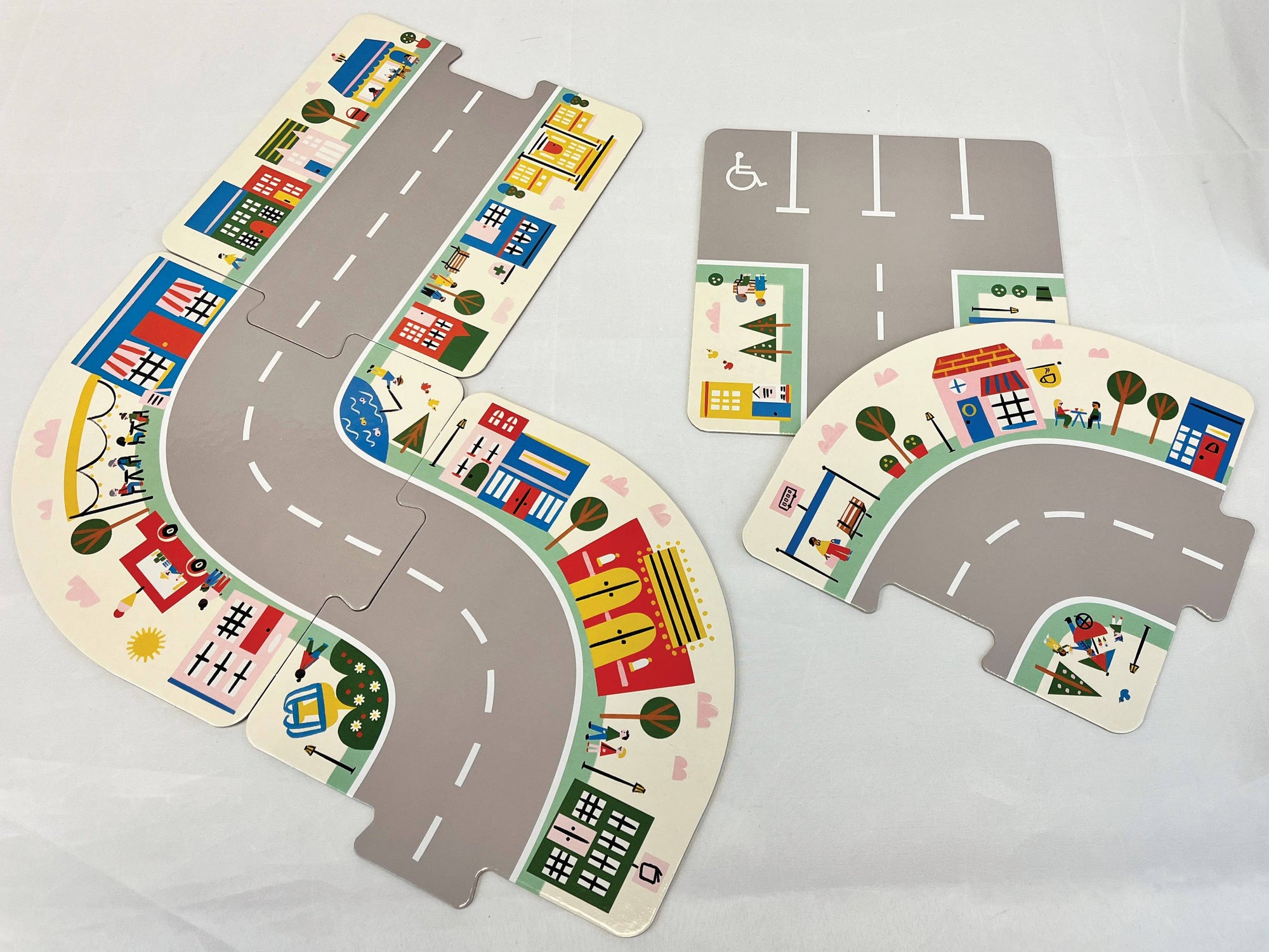 Children's toy road set with colorful roads and buildings on a white background