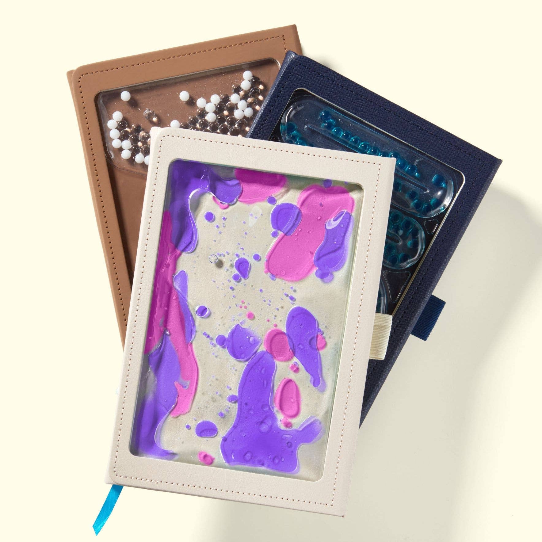 Sensory journals with colorful splatter design on a light background