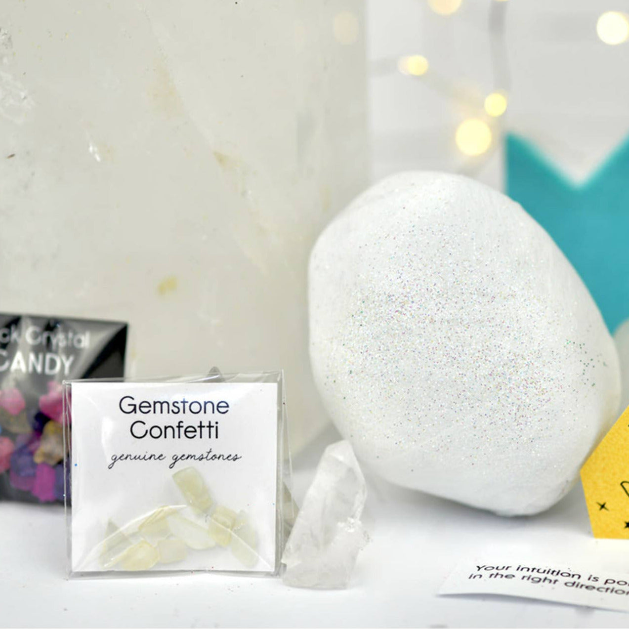 White surprise ball with packaging and text on a light background