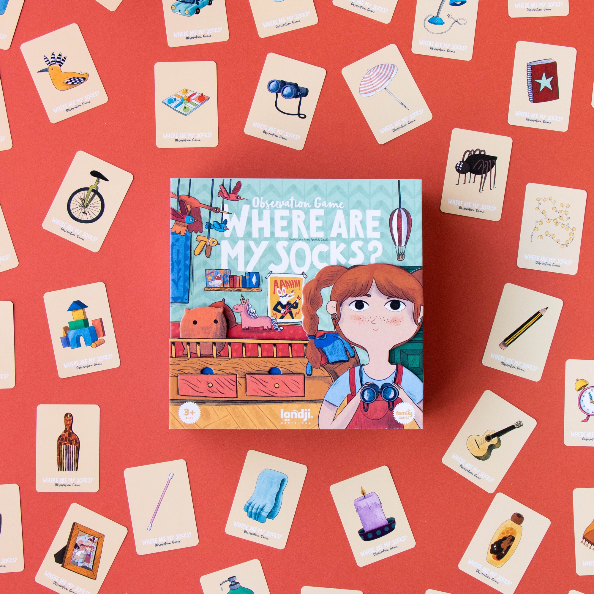 Children's book titled 'Where Are My Socks?' surrounded by scattered cards on a red background