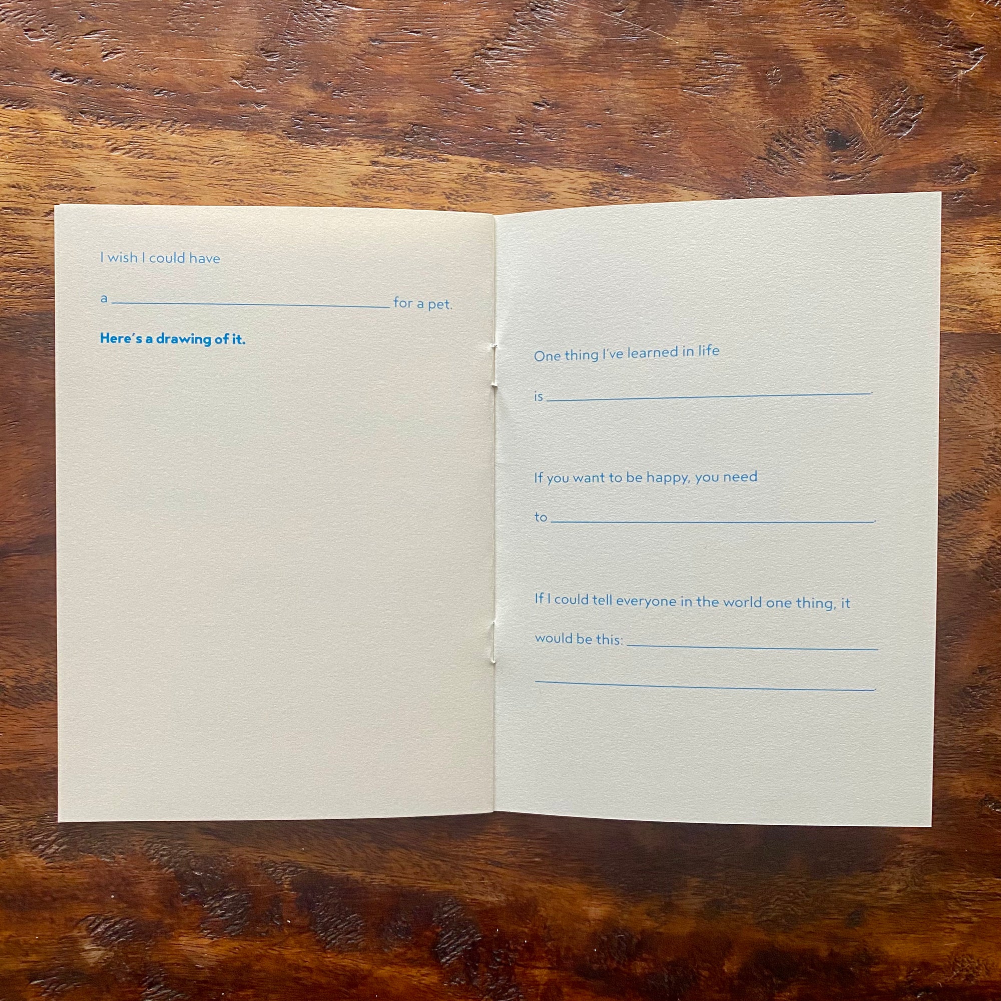 Open book with printed text on a wooden surface