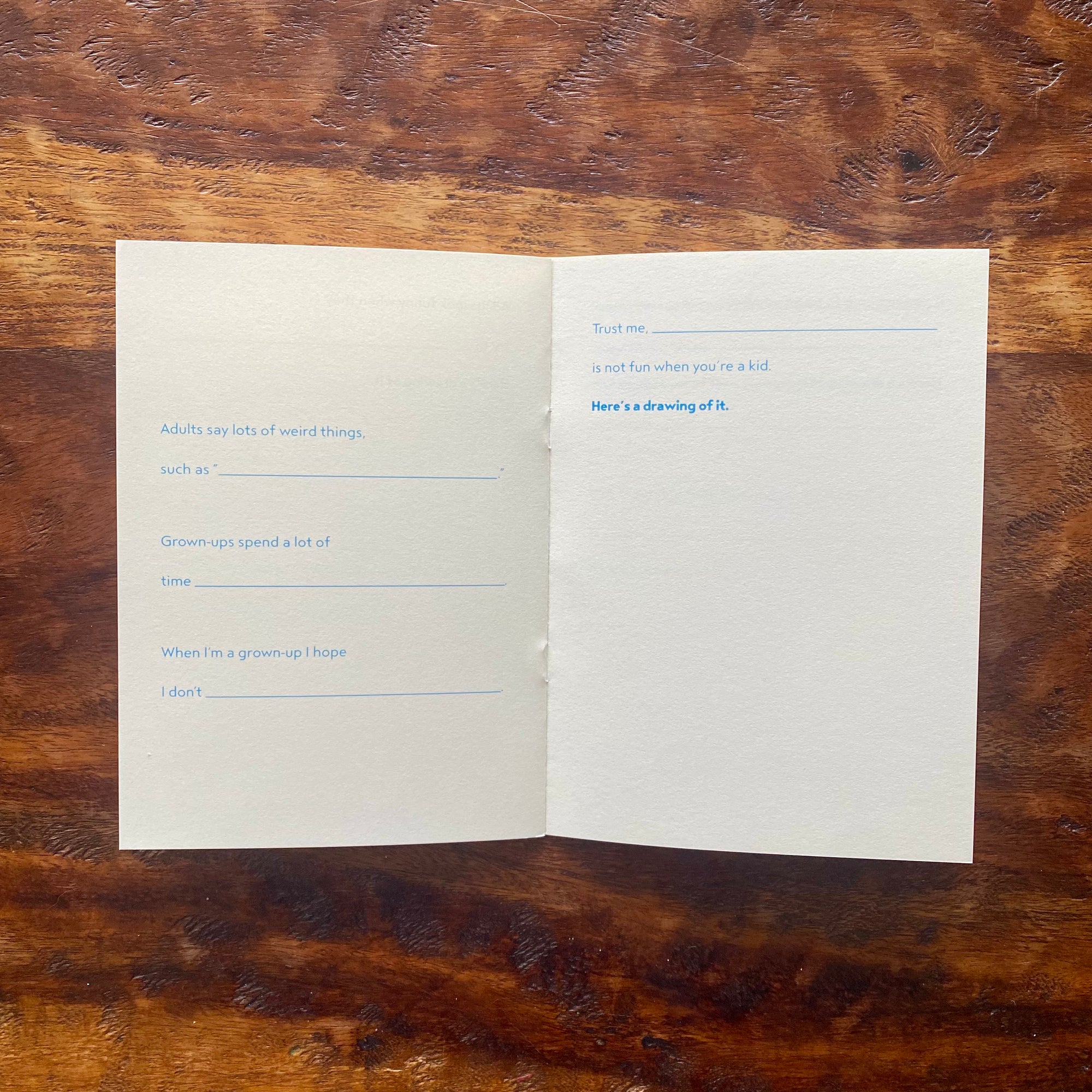 Open book with text on a wooden surface