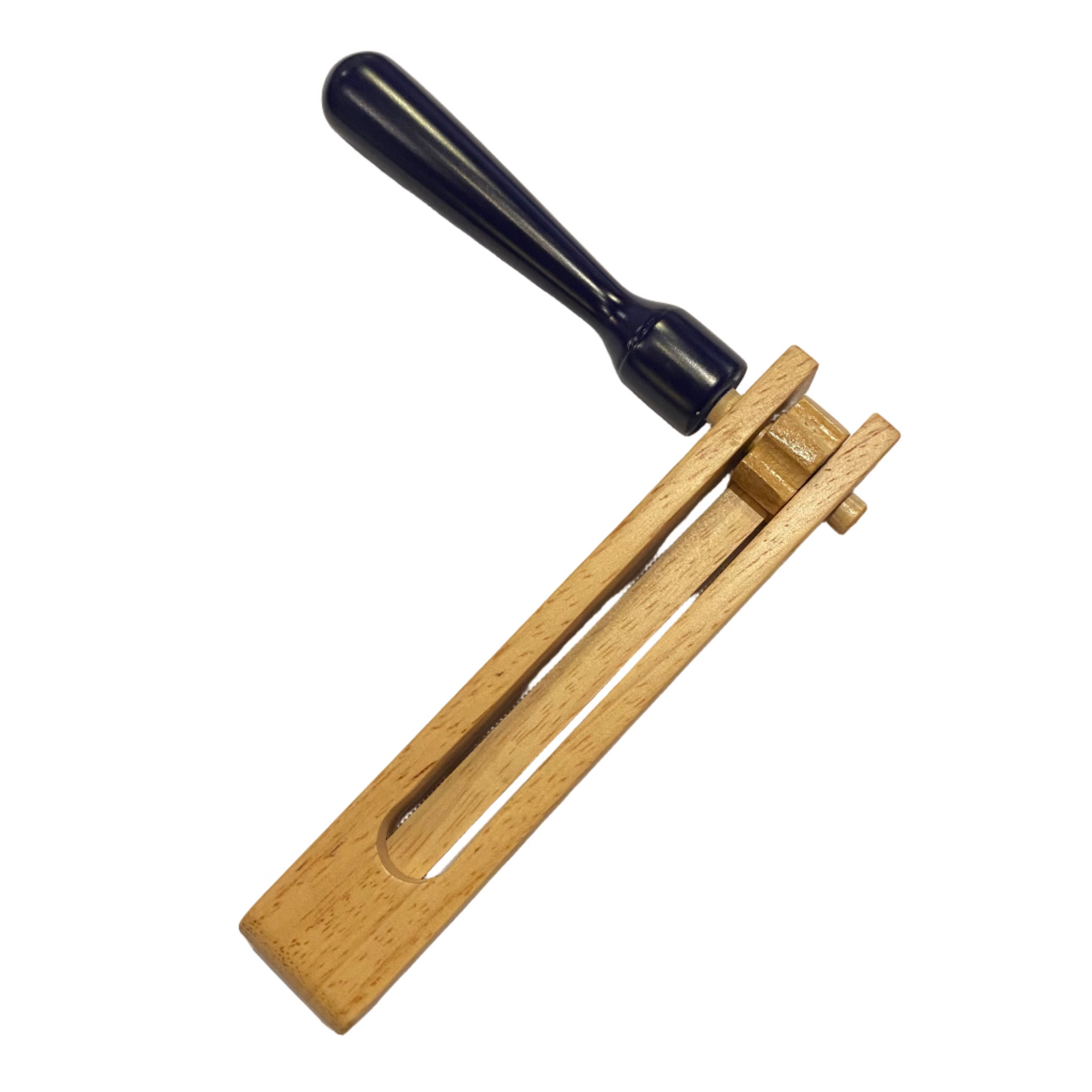 Wooden tool and black handle on a white sheet of paper on a wooden surface