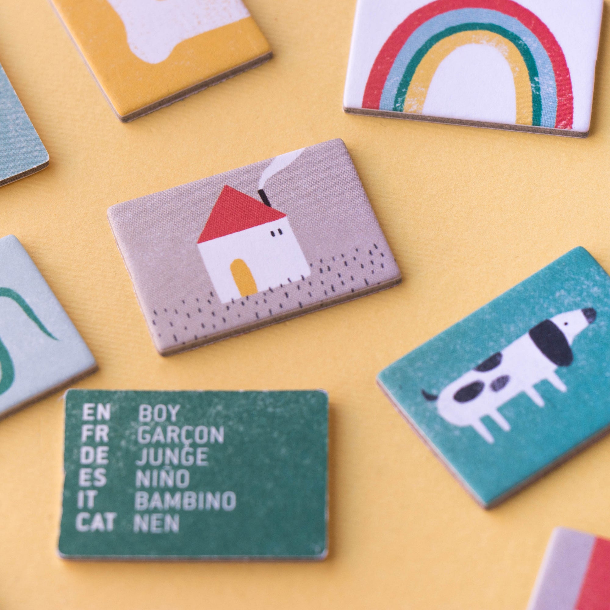 Collection of small rectangular cards with various illustrations and text on a yellow background