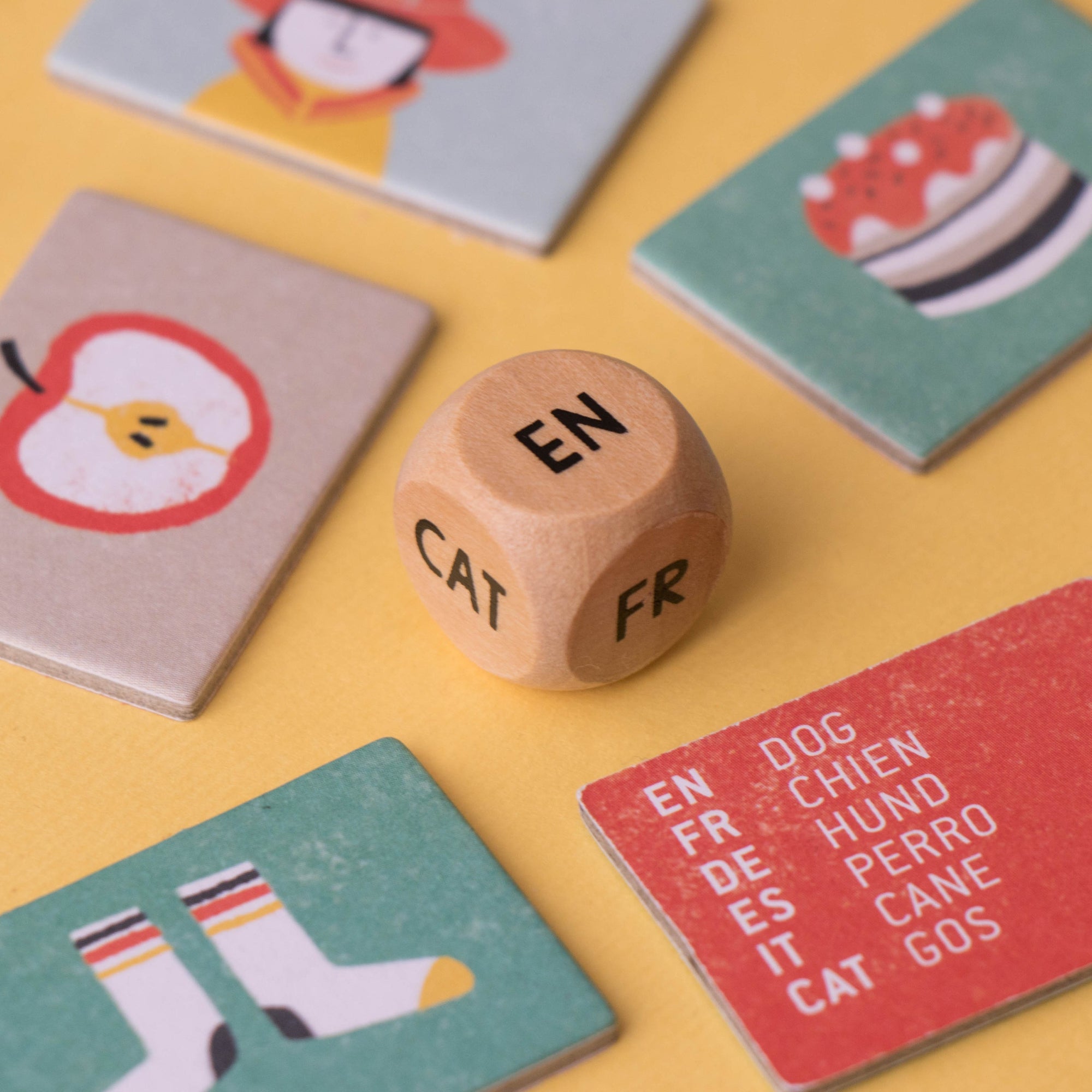 Dice with letters and word cards on a yellow background