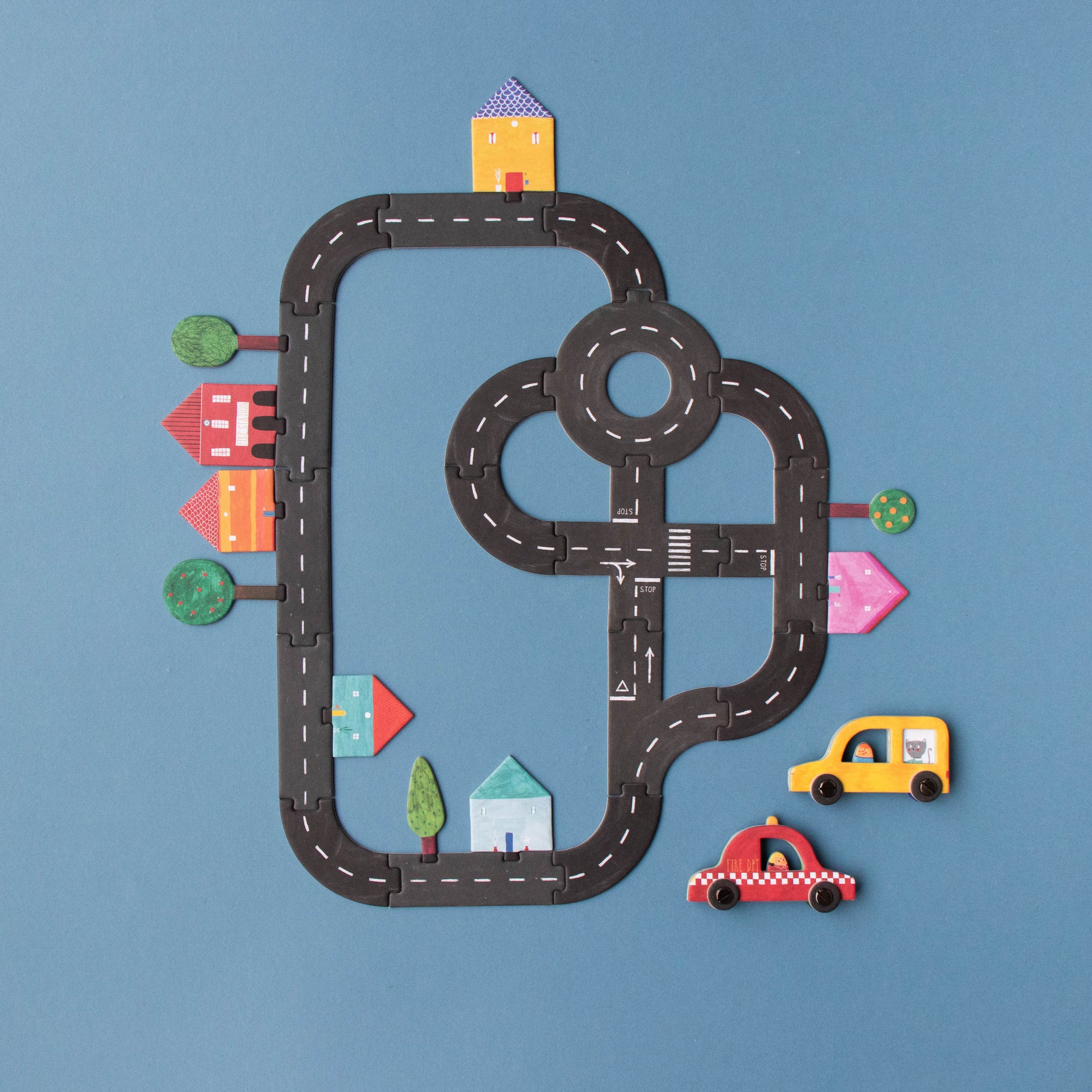 Toy road set with cars on a blue background