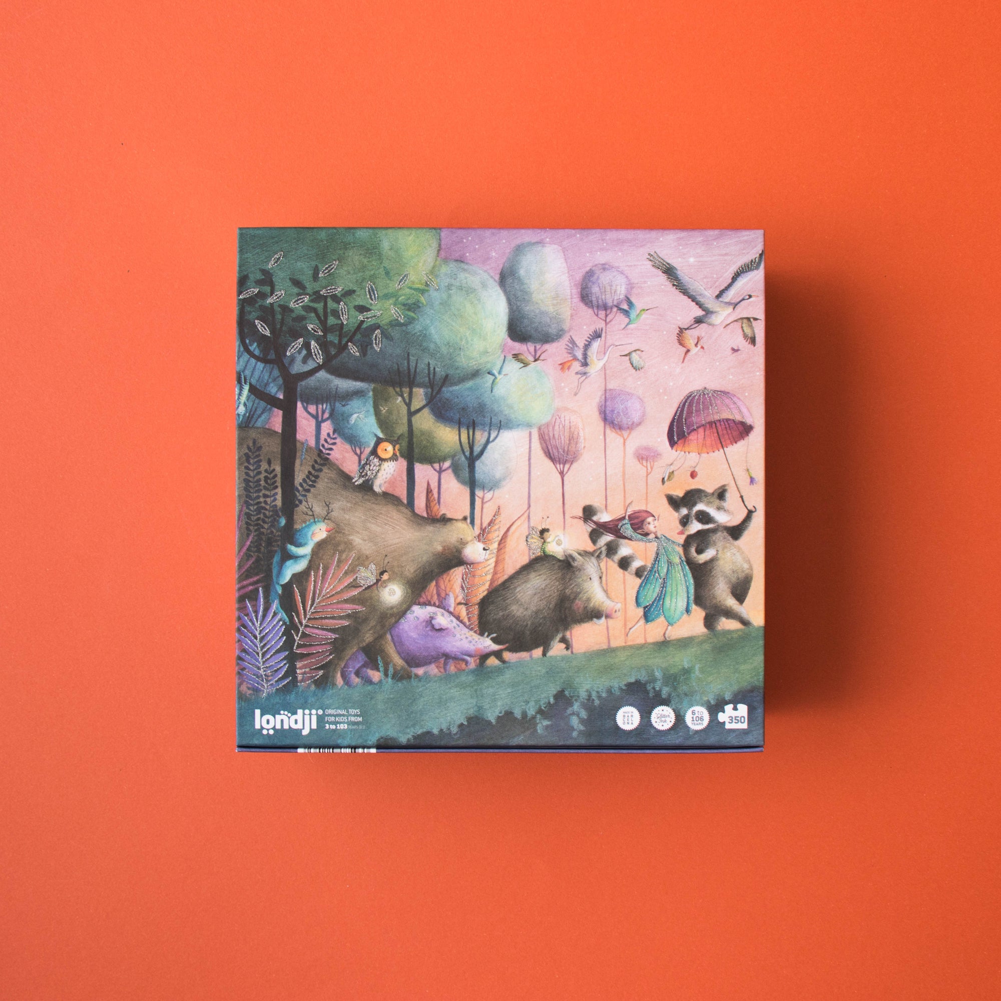 Puzzle box with colorful illustration of animals and balloons on an orange background