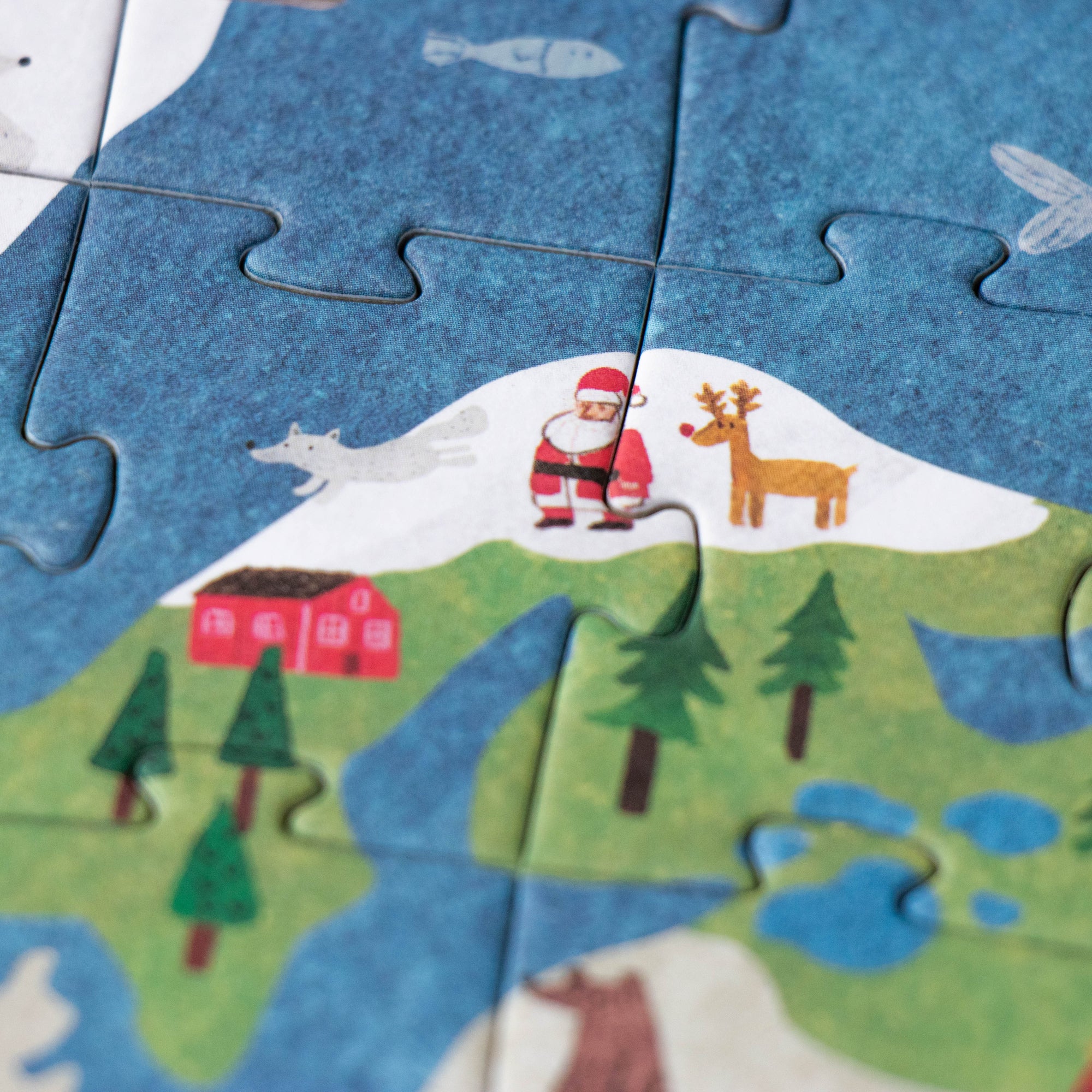 Children's puzzle with a Santa Claus and reindeer design on a blue background