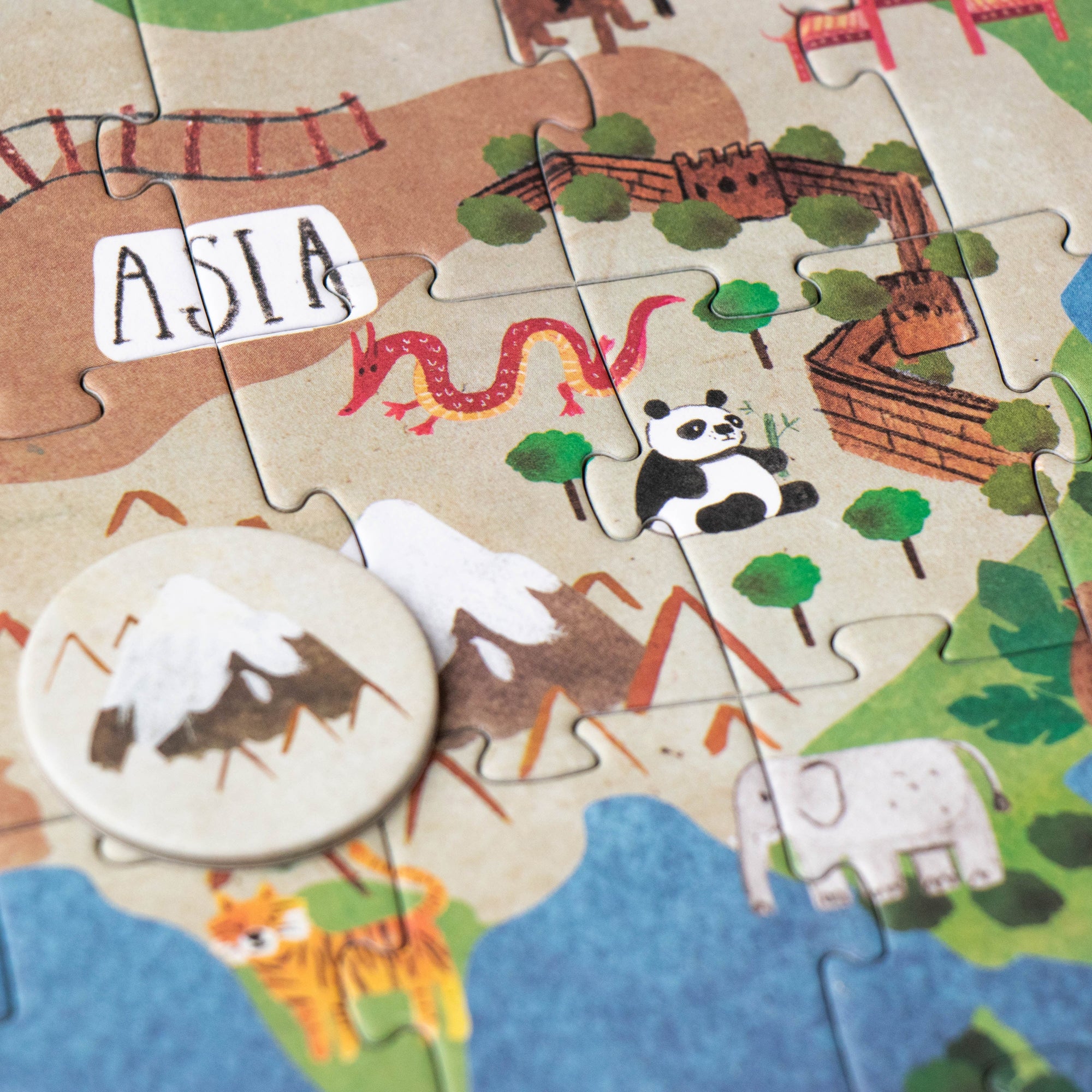 Children's puzzle map of Asia with animals and landmarks