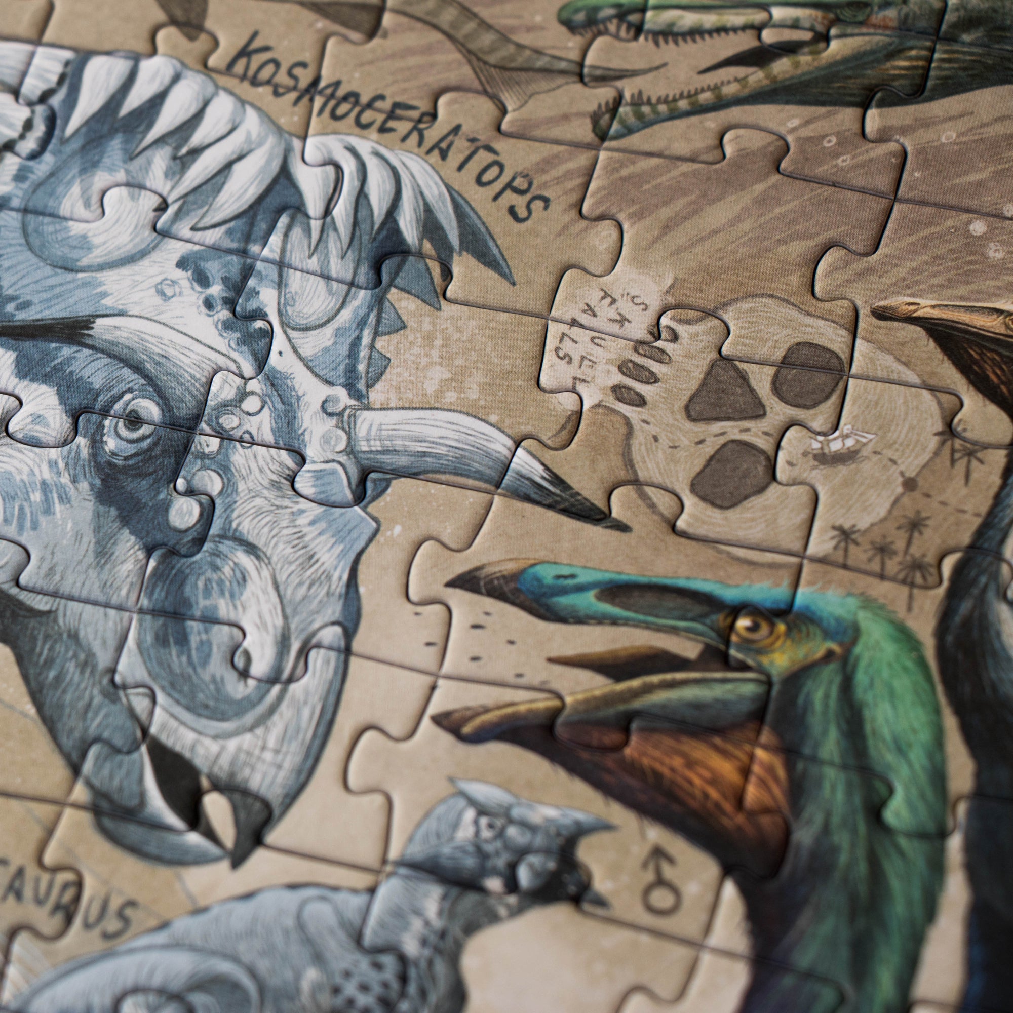 Close-up of a dinosaur-themed puzzle with partially completed pieces.