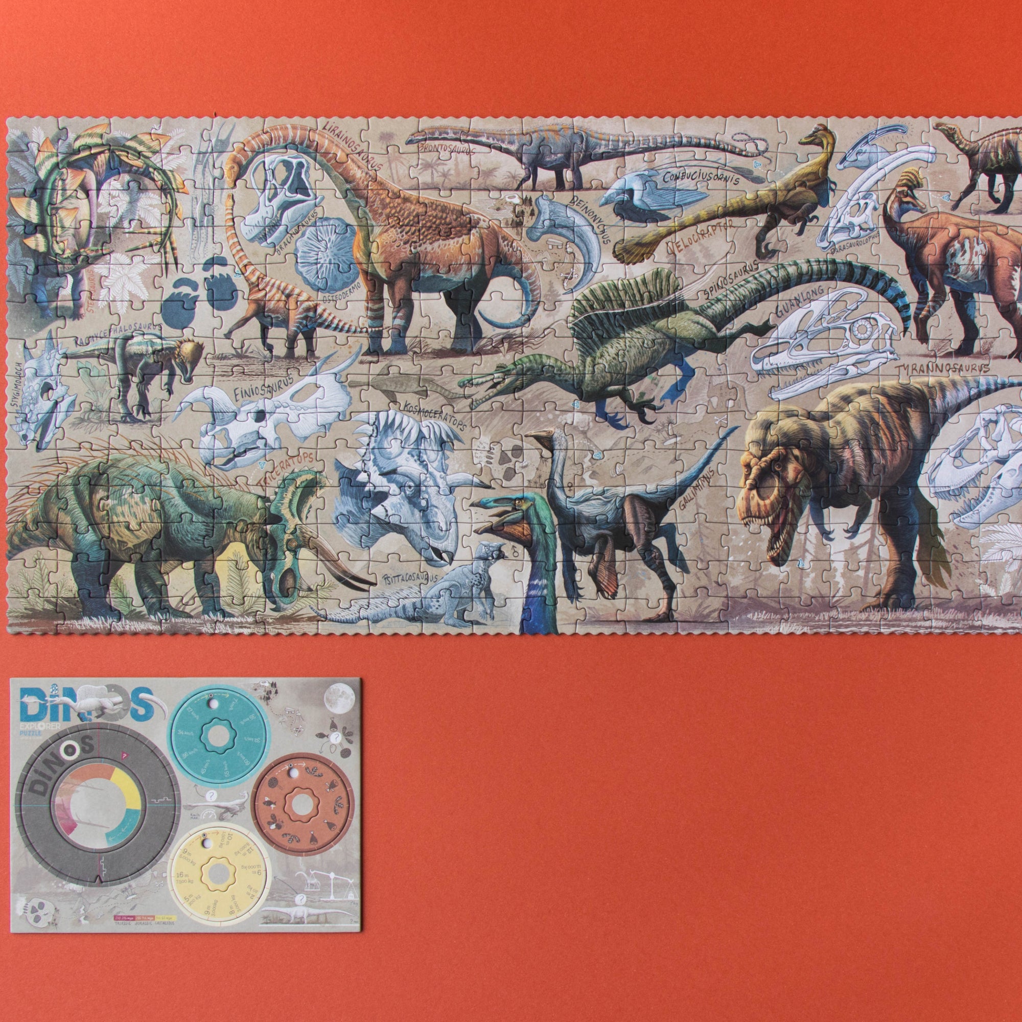 Dinosaur-themed puzzle with colorful pieces on a red background