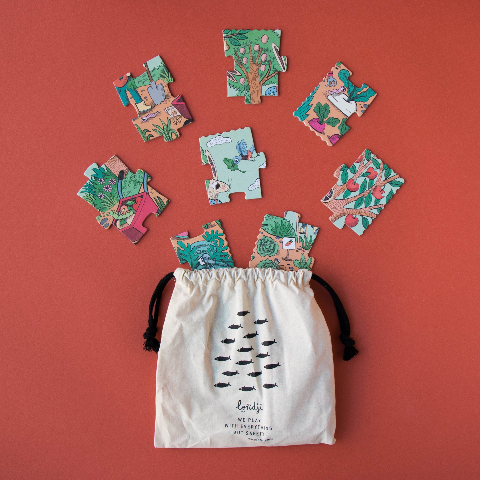 Colorful puzzle pieces spilling out of a drawstring bag on a red background