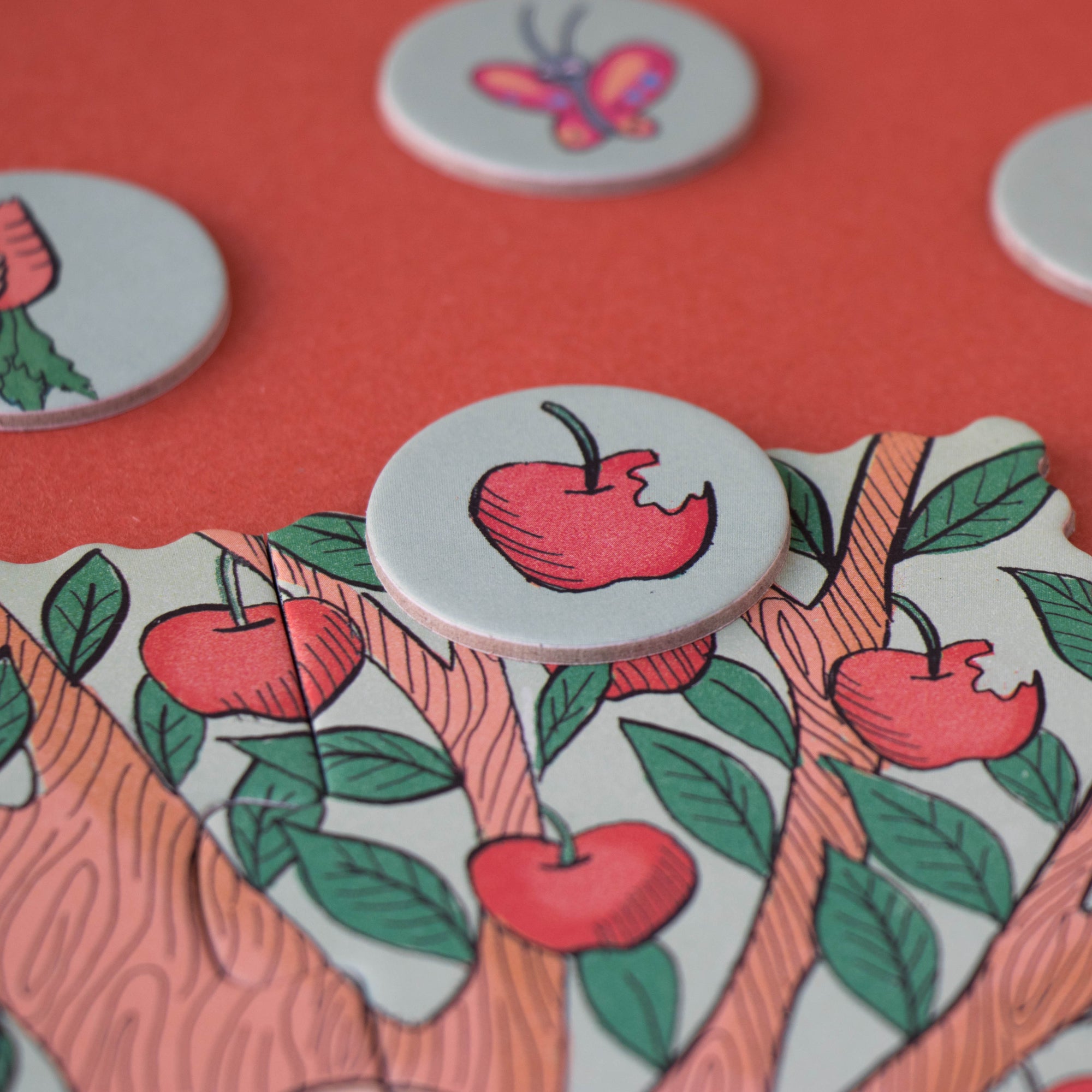 Decorative buttons with apple designs on a red background