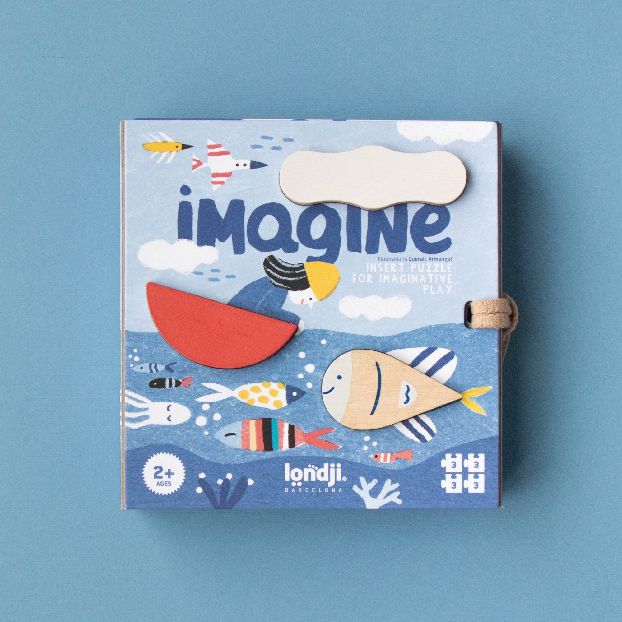 Children's puzzle titled 'imagine' with a colorful cover on a blue background
