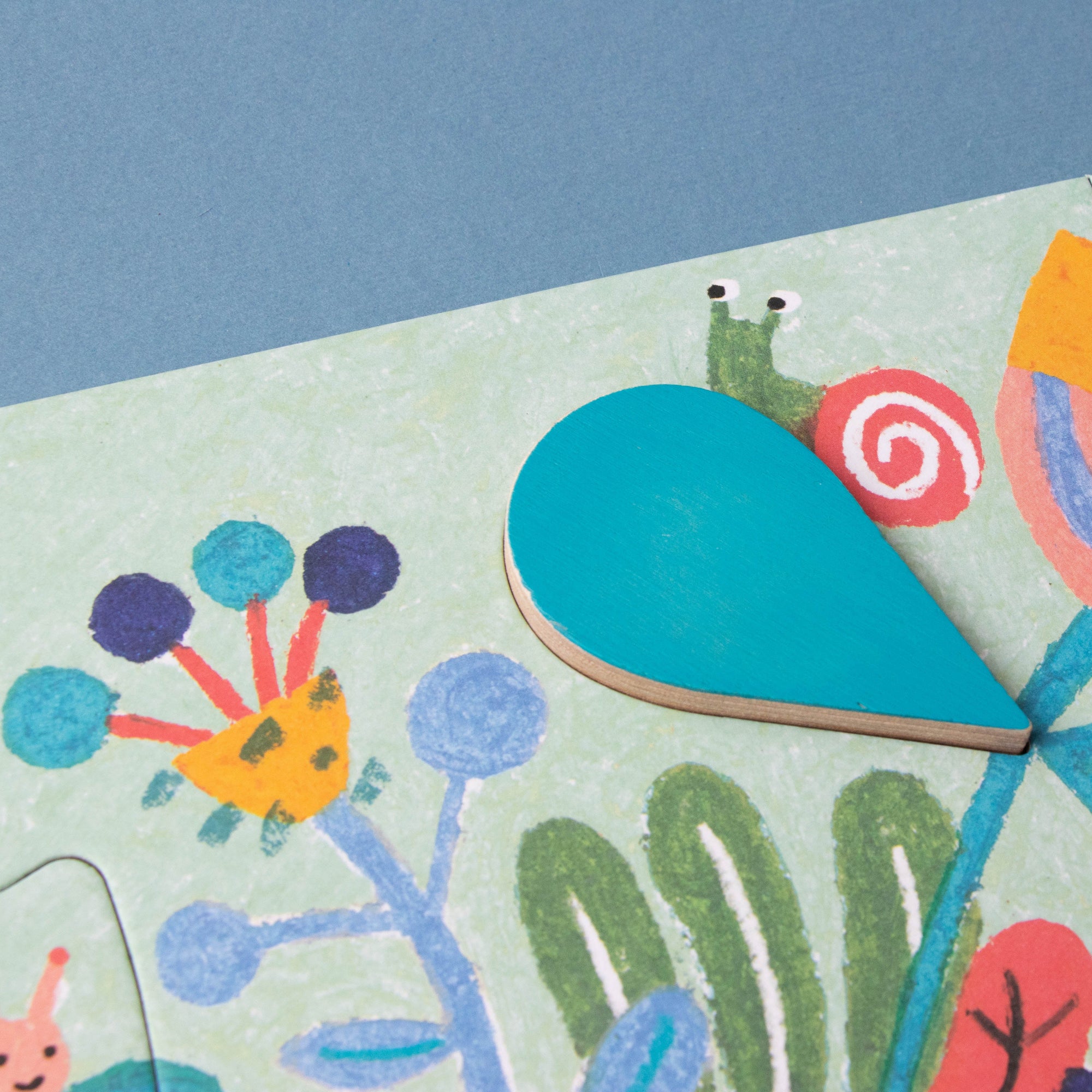 Children's puzzle with colorful garden-themed pieces on a blue background