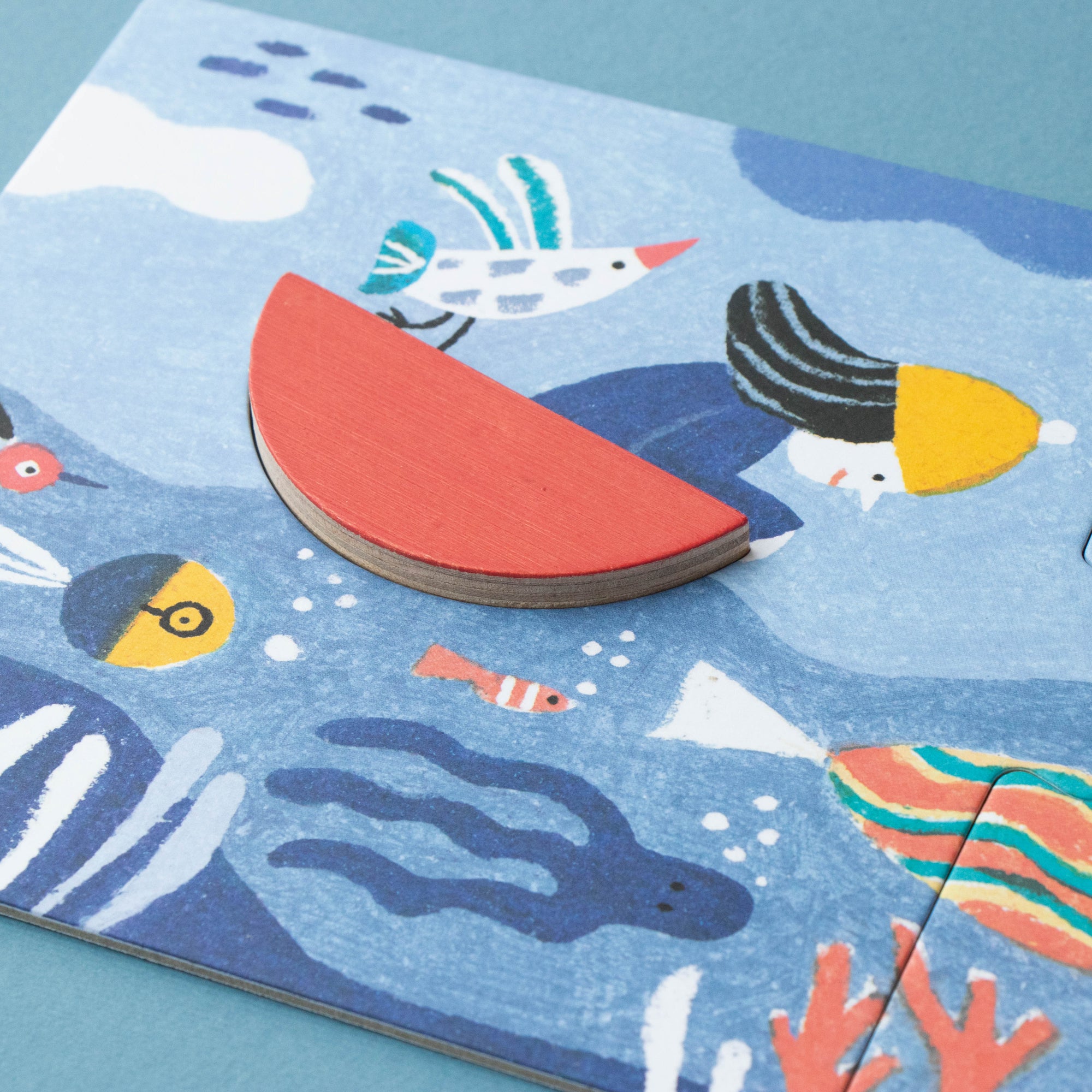 Children's puzzle with colorful sea-themed pieces on a blue background