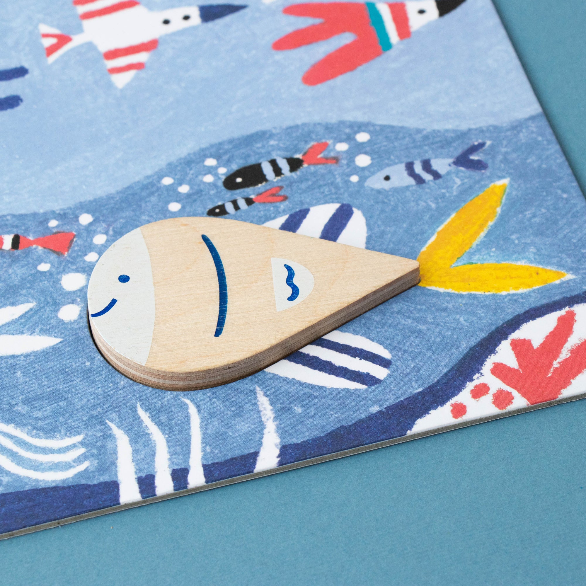 Children's puzzle with colorful fish illustrations on a blue background
