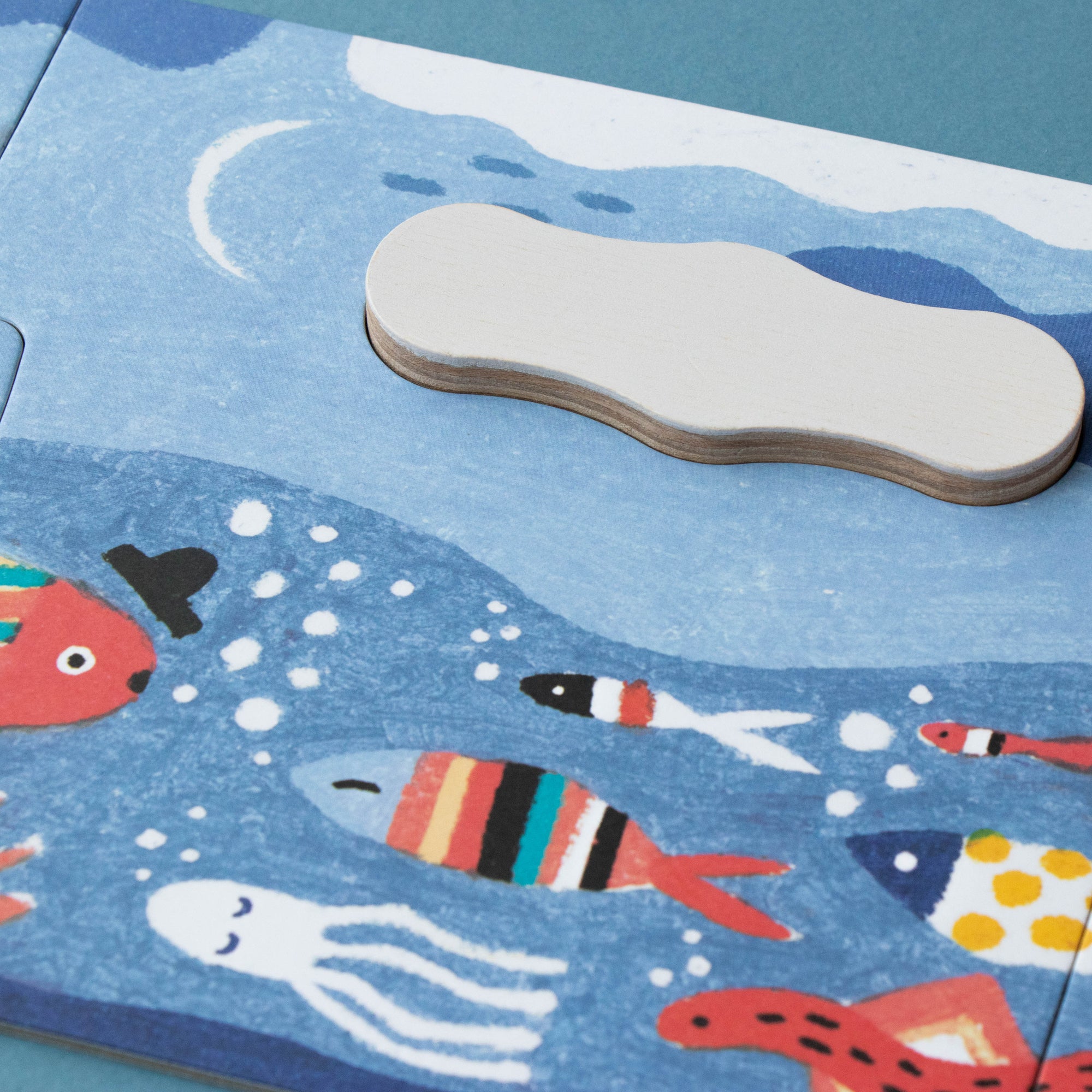 Children's puzzle with ocean-themed design featuring fish and an octopus on a blue background.