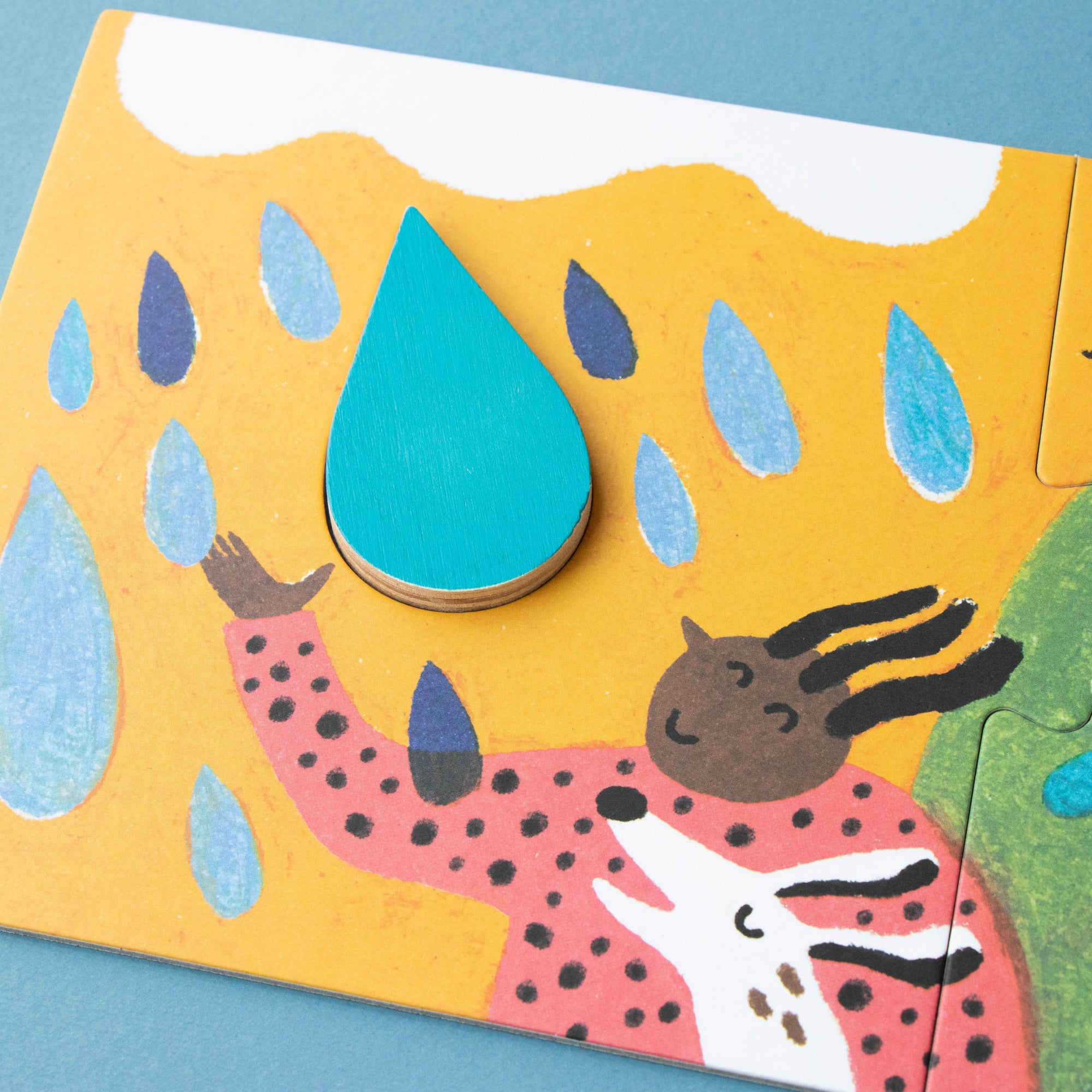 Children's puzzle with colorful raindrop and animal design on a blue background