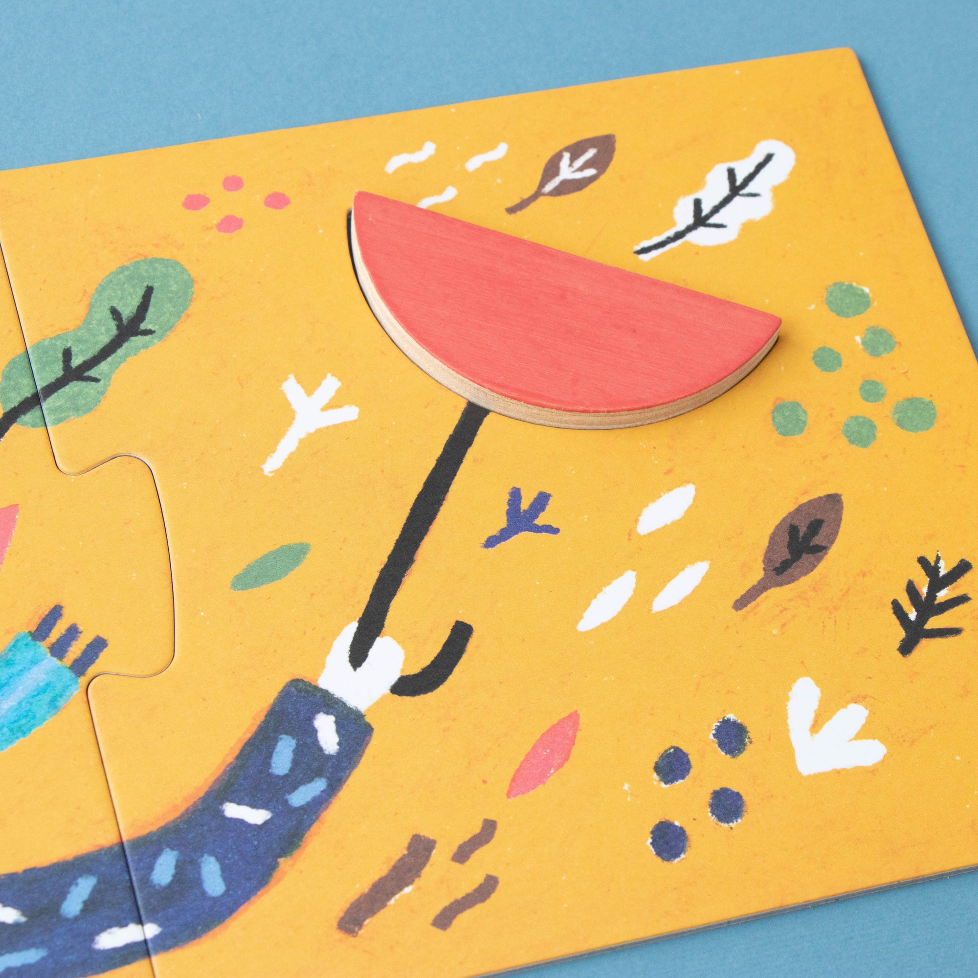 Children's puzzle with a hand holding an umbrella on a yellow background