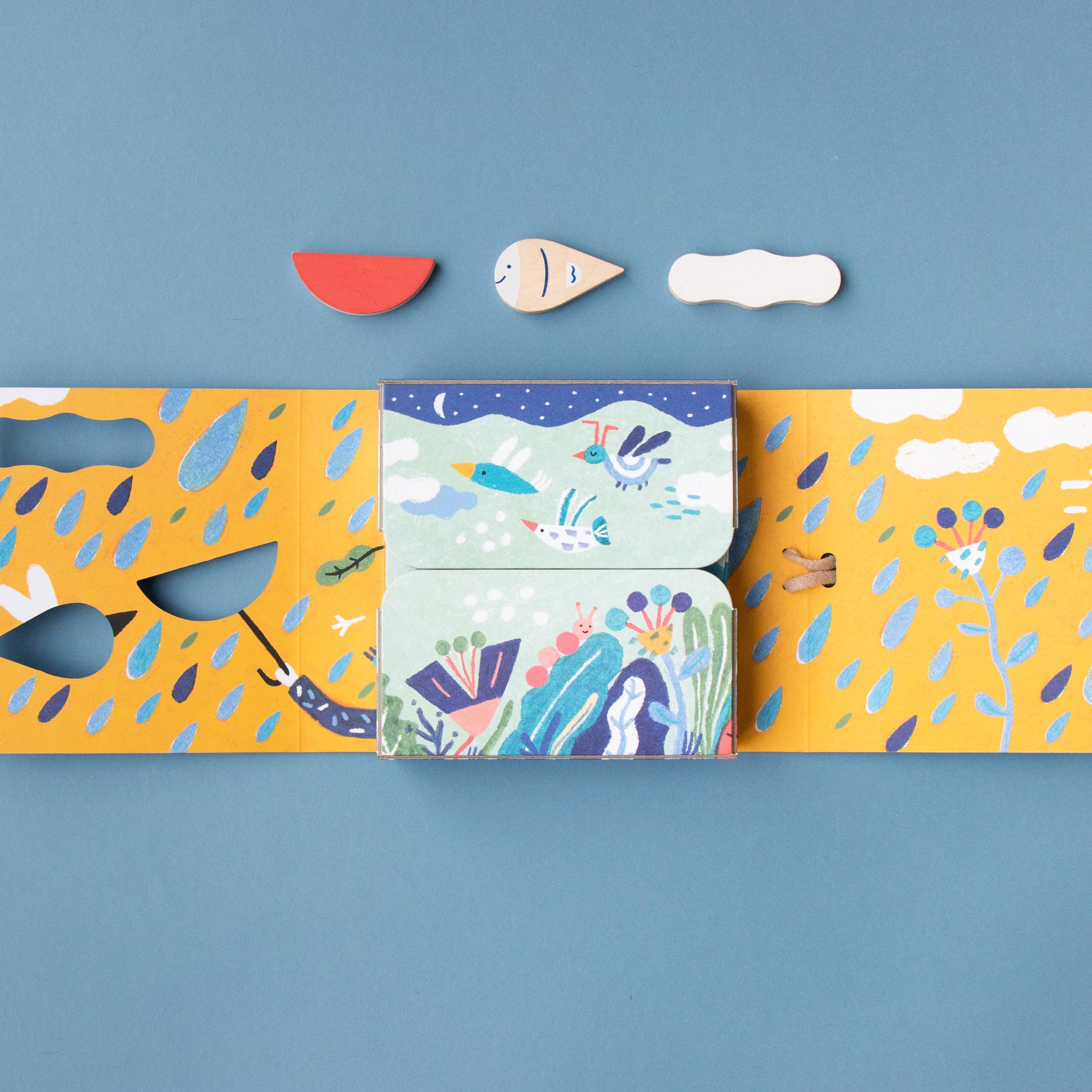 Set of colorful cardboards with cut-out shapes on a blue background