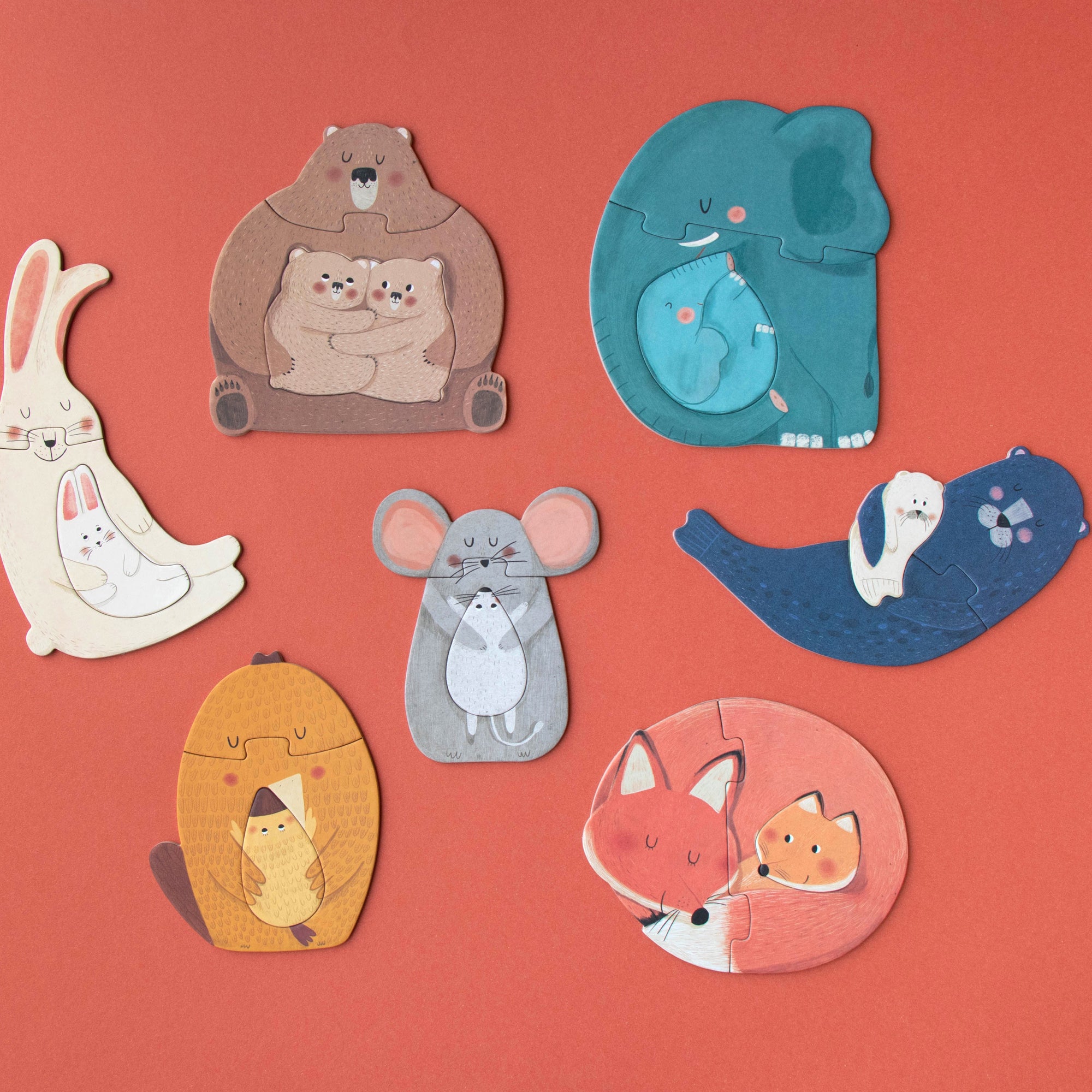 Set of animal-shaped pins on a red background