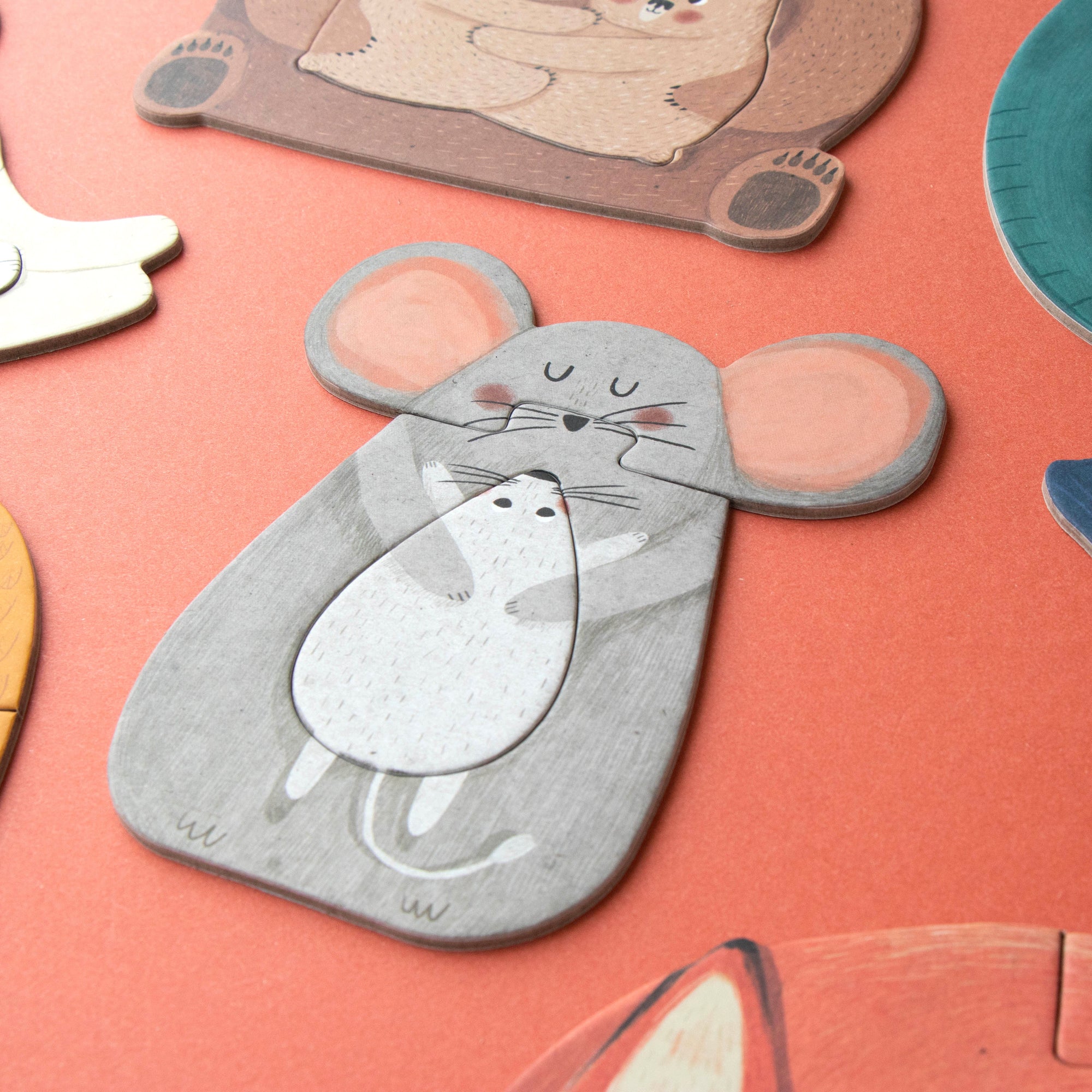 Collection of animal-shaped puzzle pieces on a pink background