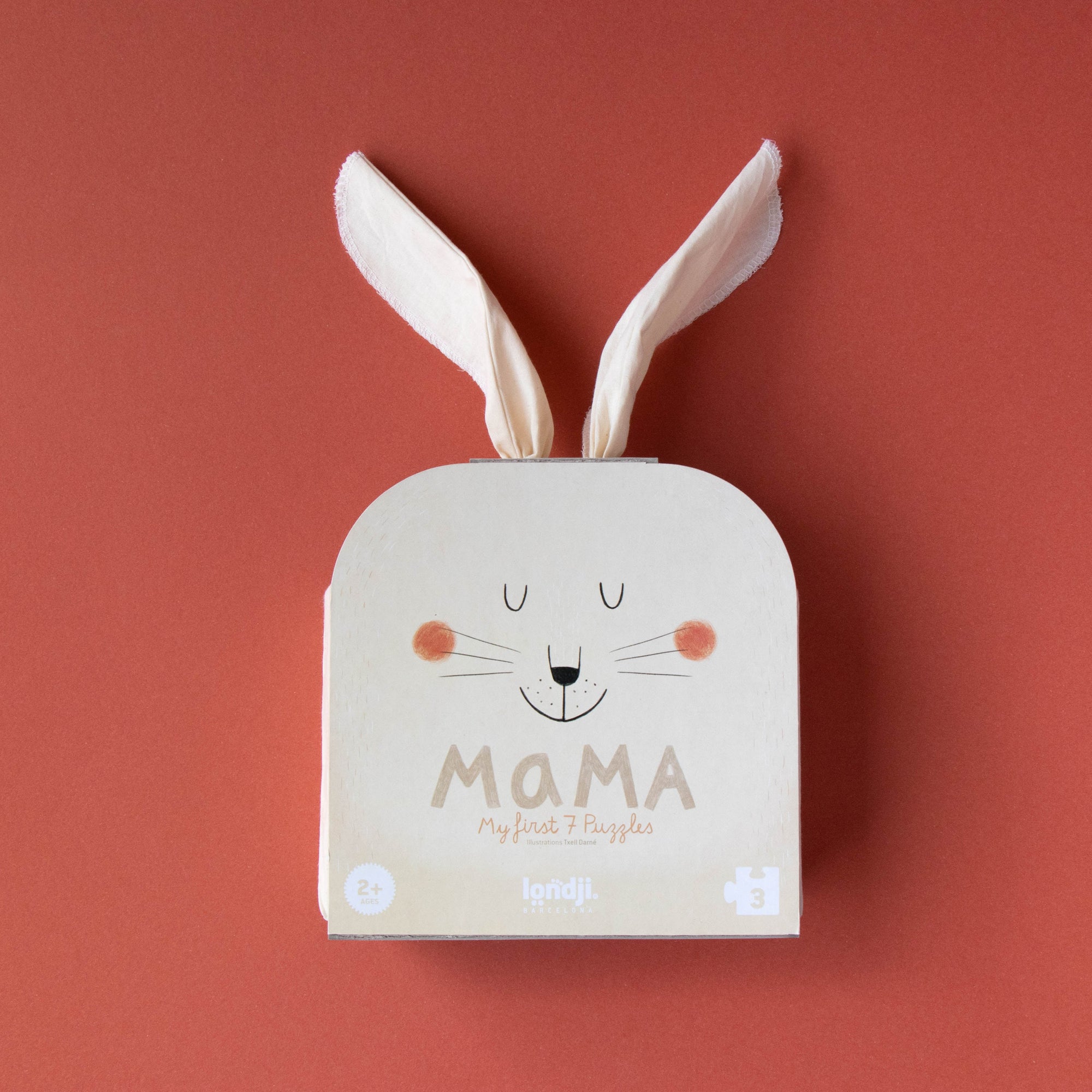 Baby book with bunny ears and 'MAMA' text on a red background