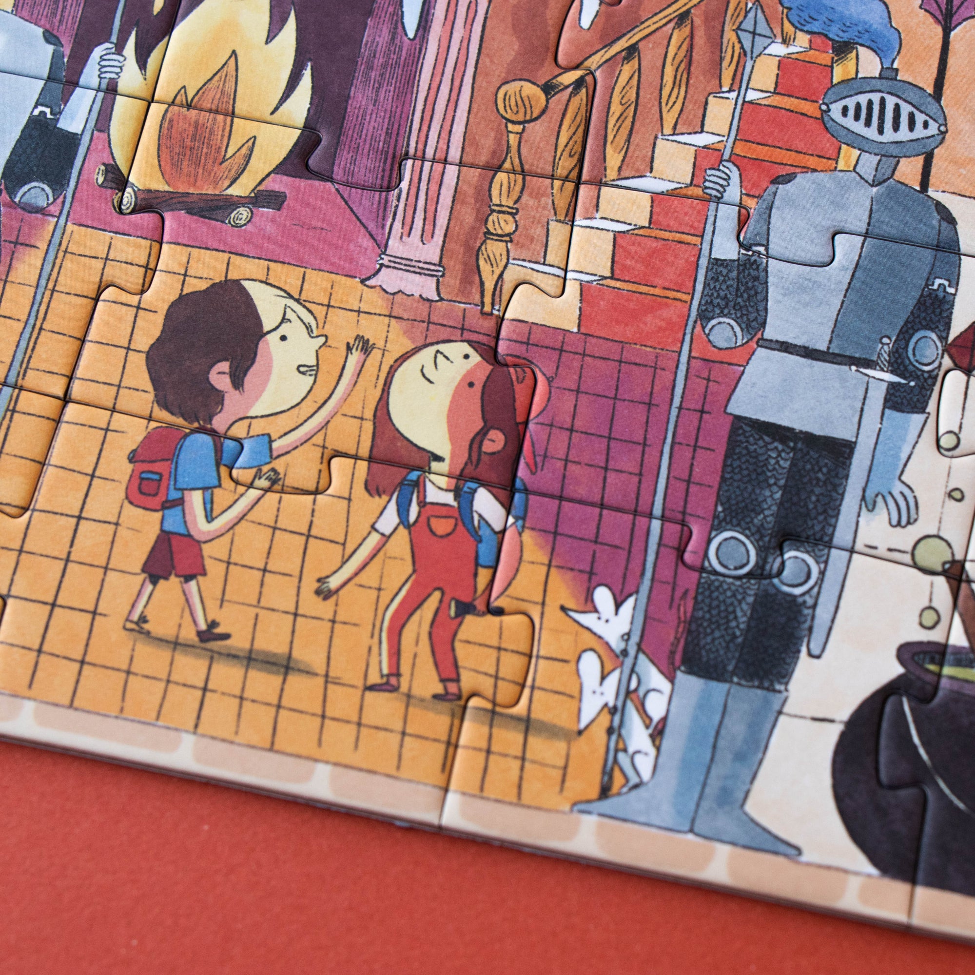 Children's puzzle with cartoon characters and knights on a red surface