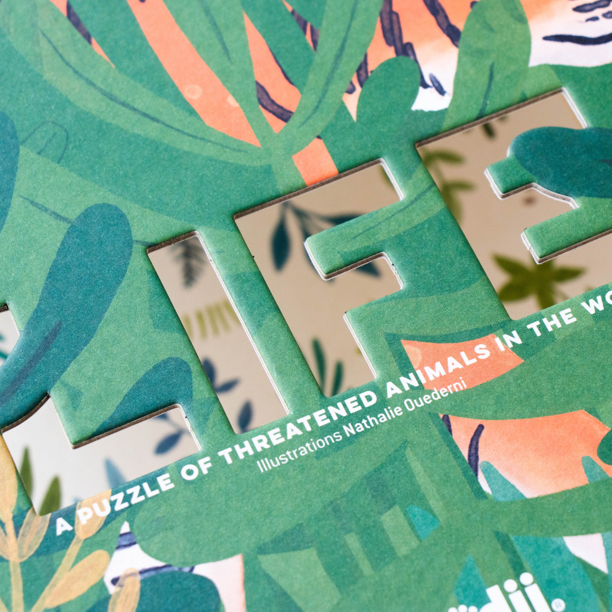Close-up of a puzzle with nature-themed pieces and text about threatened animals.