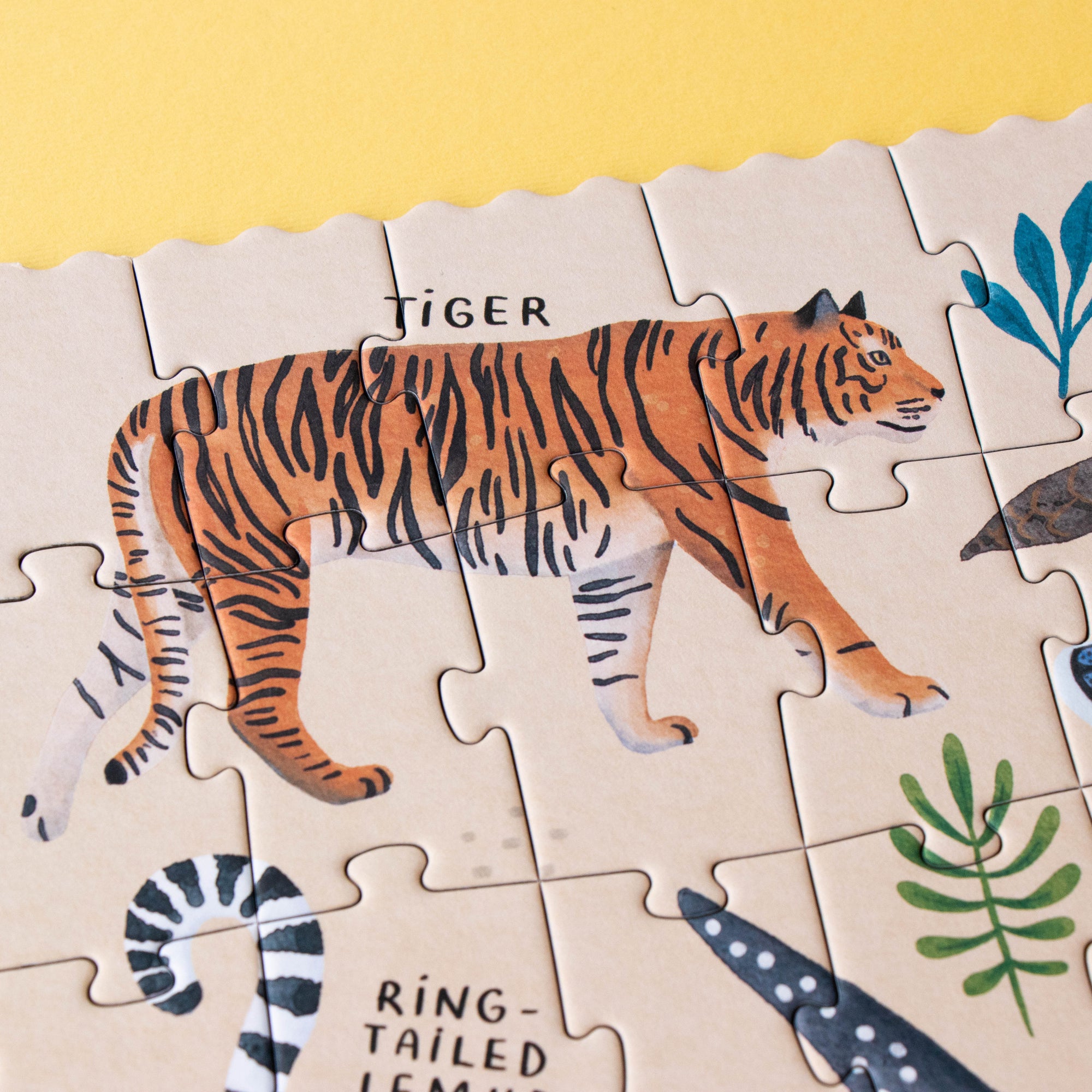 Jigsaw puzzle with a tiger illustration on a yellow background
