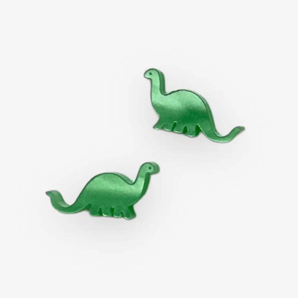 A pair of green dinosaur earrings on a white background