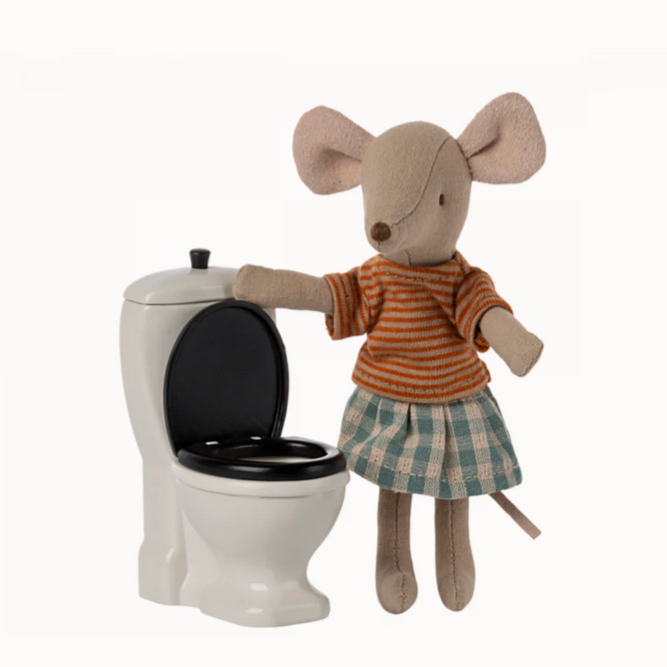 A toy mouse standing next to a small, off-white colored toilet with a black seat, designed for playsets.
