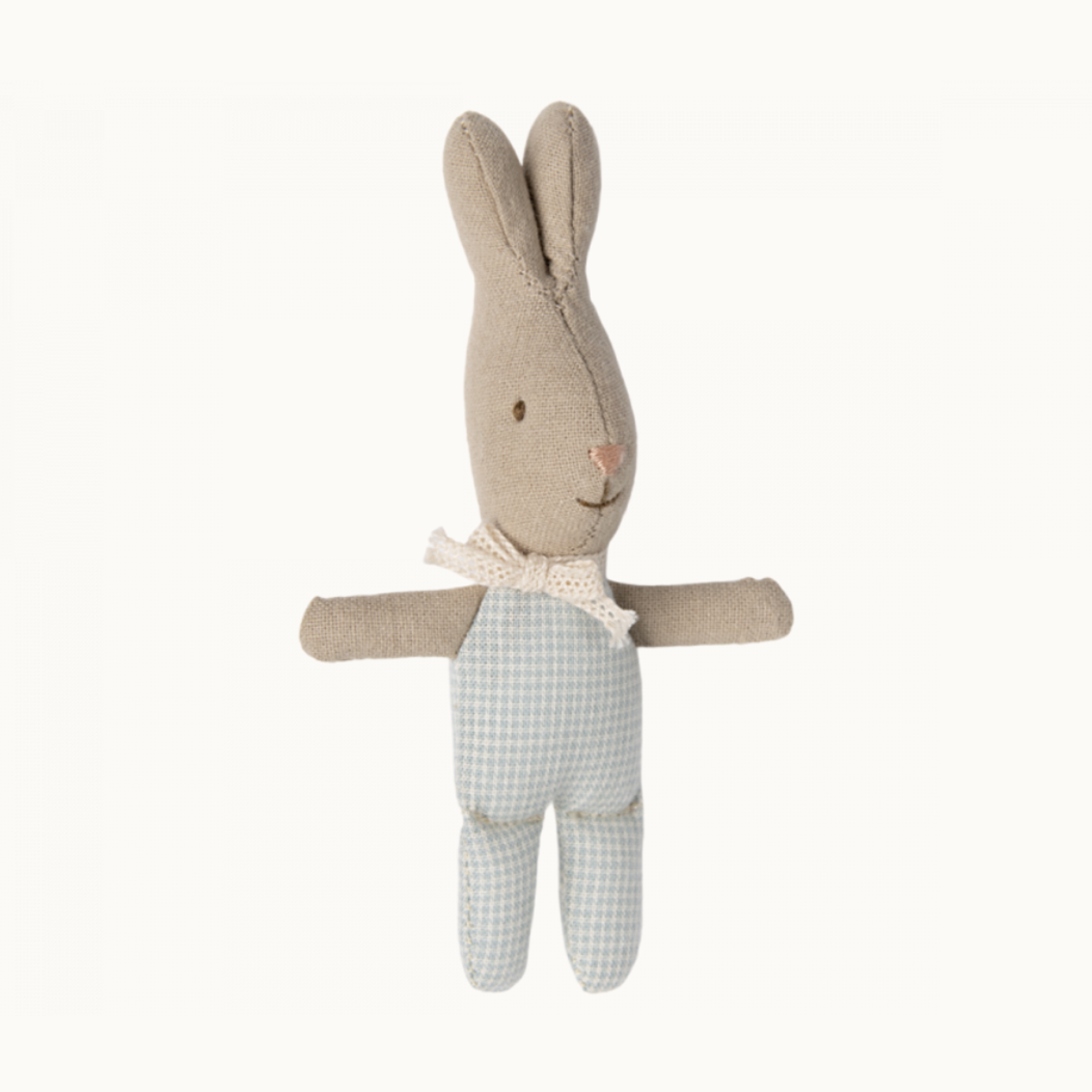 A small plush toy resembling a rabbit with a light blue checkered outfit.