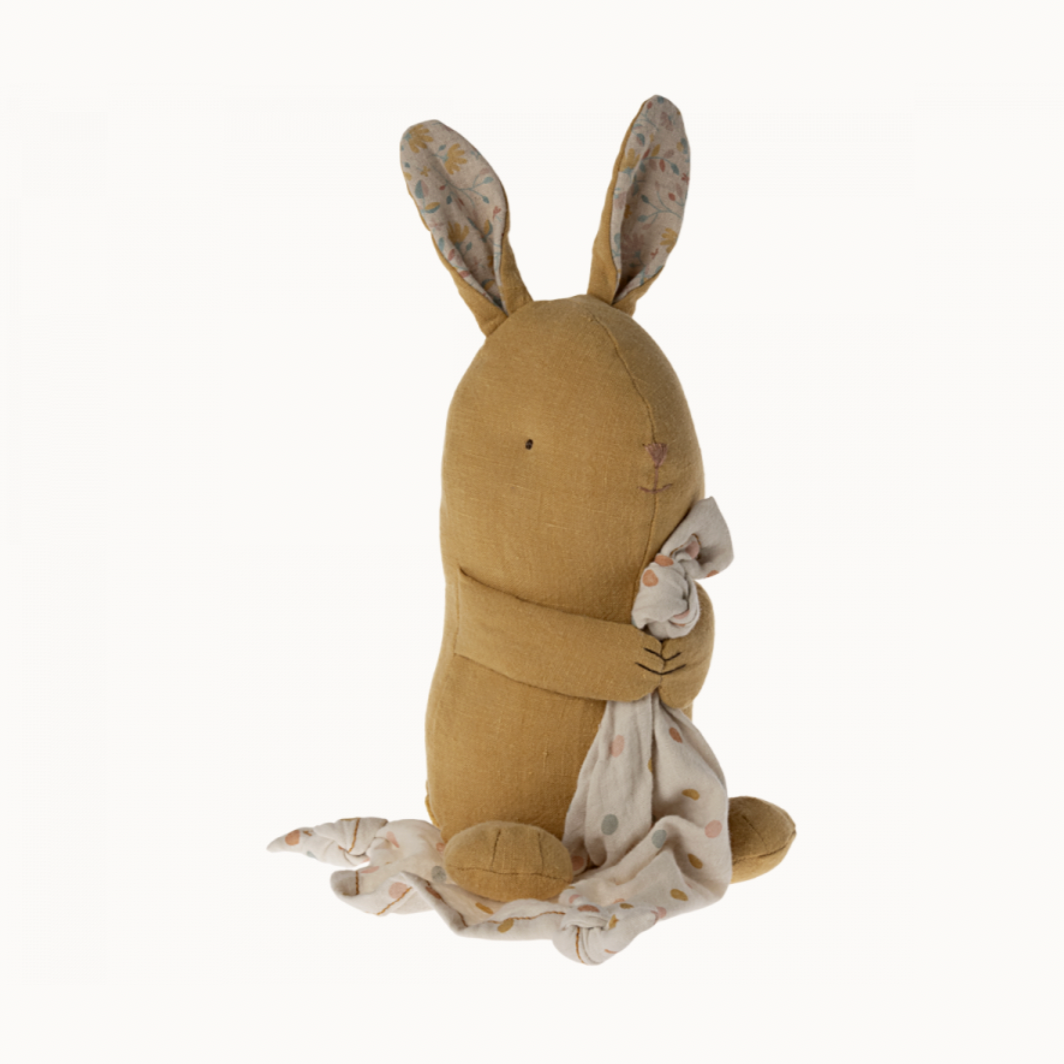 Stuffed bunny toy with floral patterned ears and a soft cloth body, holding a small cloth, against a white background.