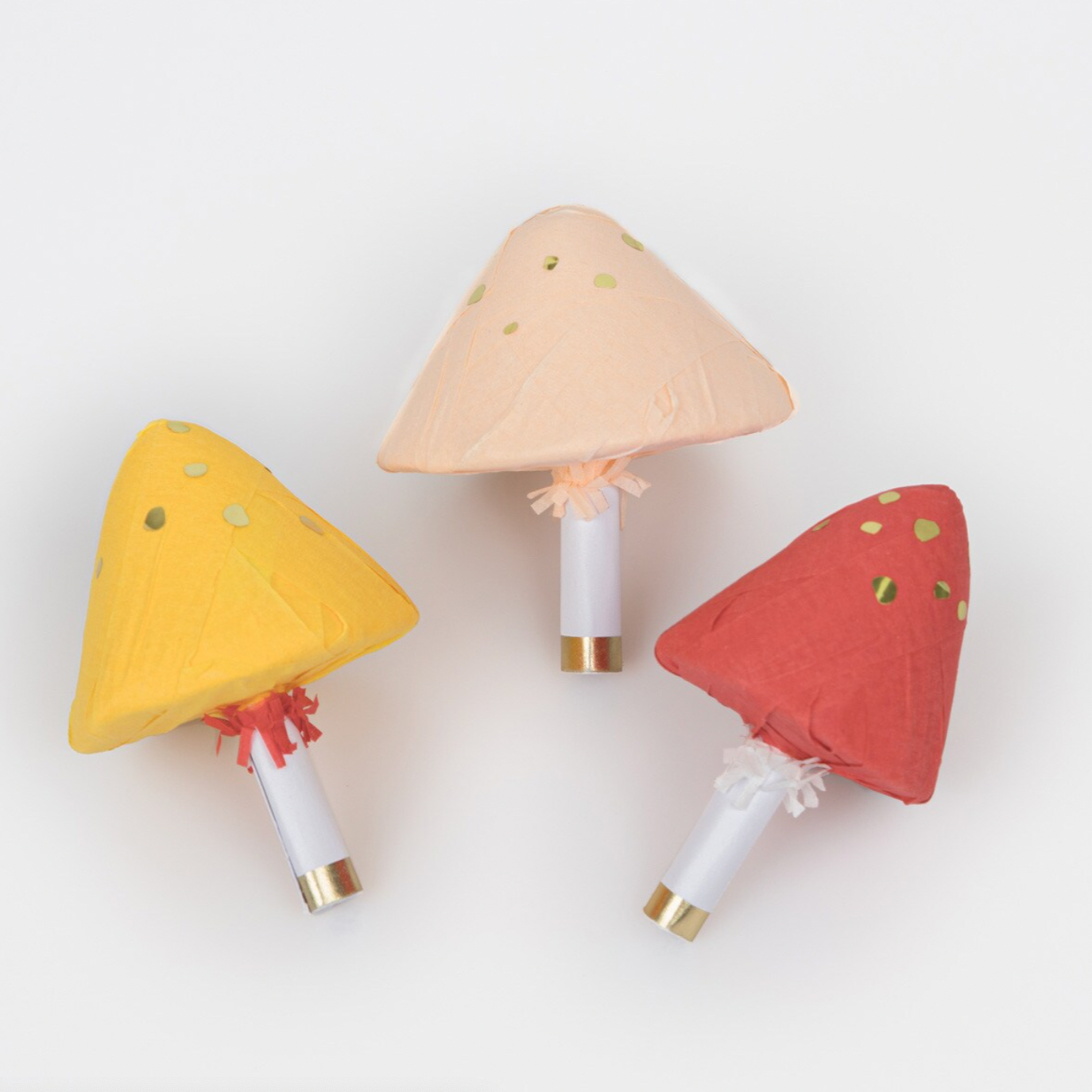 A set of three mushroom-shaped party favors with gold foil details and different colored caps, displayed against a white background.