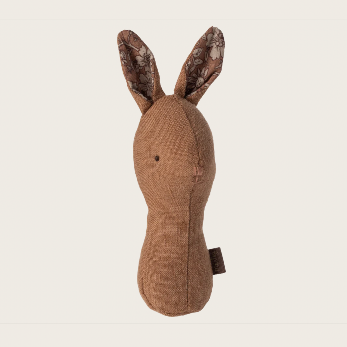 A brown fabric bunny rattle with patterned ears, designed for babies.