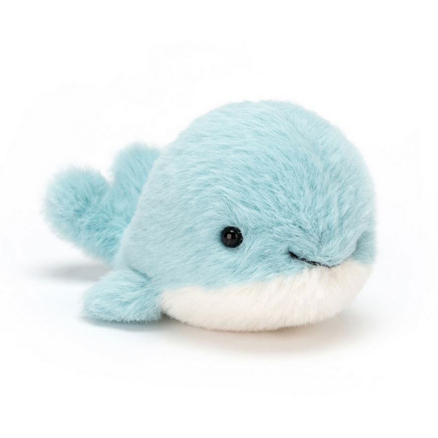 A plush toy resembling a small blue whale with a white belly and black eyes, featuring a soft, fluffy texture.