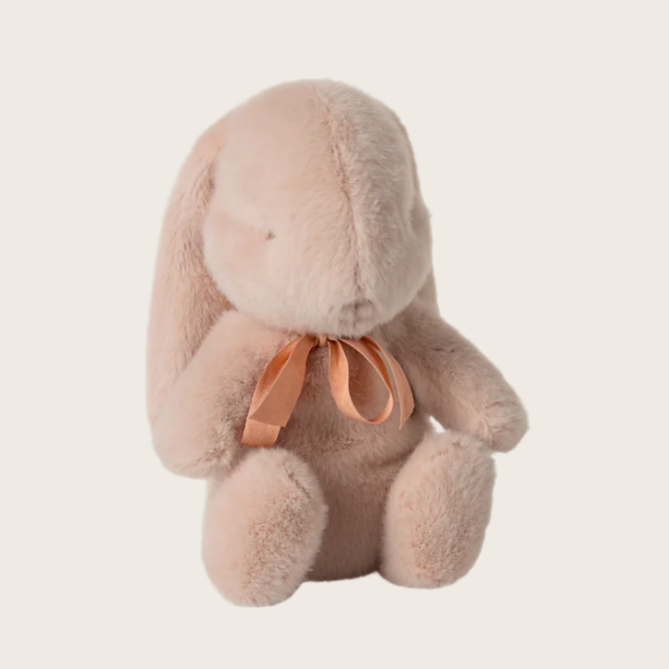 A plush toy depicting a bunny with a bow around the neck, displayed on a retail website with pricing and availability information.