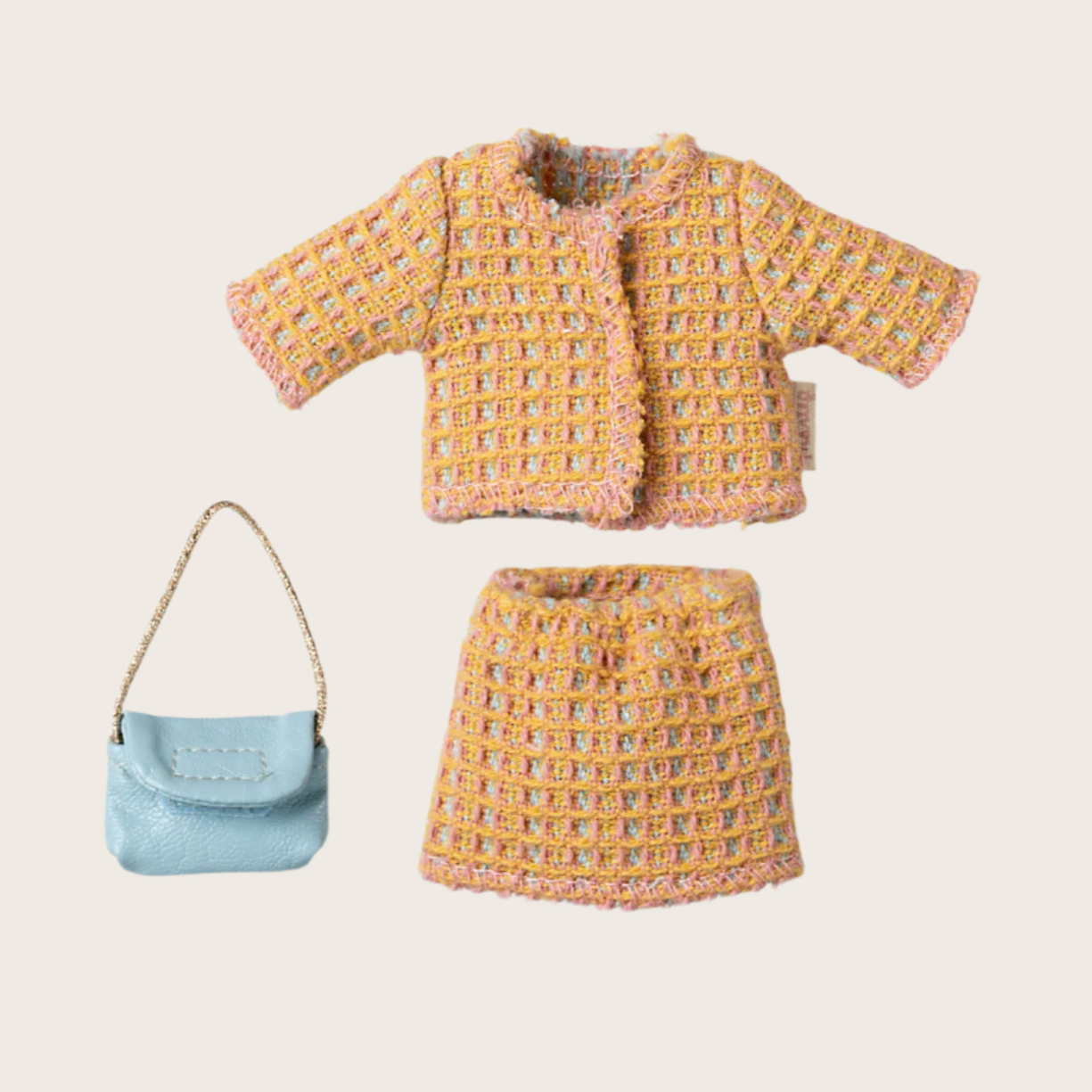 A toy outfit set for a mouse including a jacket, skirt, and a purse.