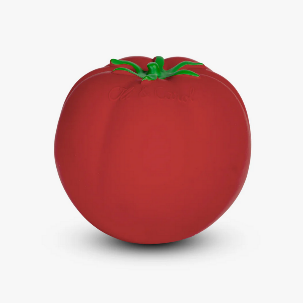 A red tomato-shaped baby toy with a green stem.