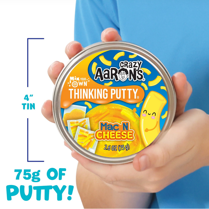 Crazy Aaron's Thinking Putty Mac N Cheese tin held by a hand with blue background