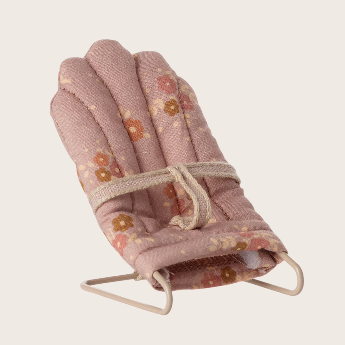 Folded baby bouncer with floral pattern on a white background