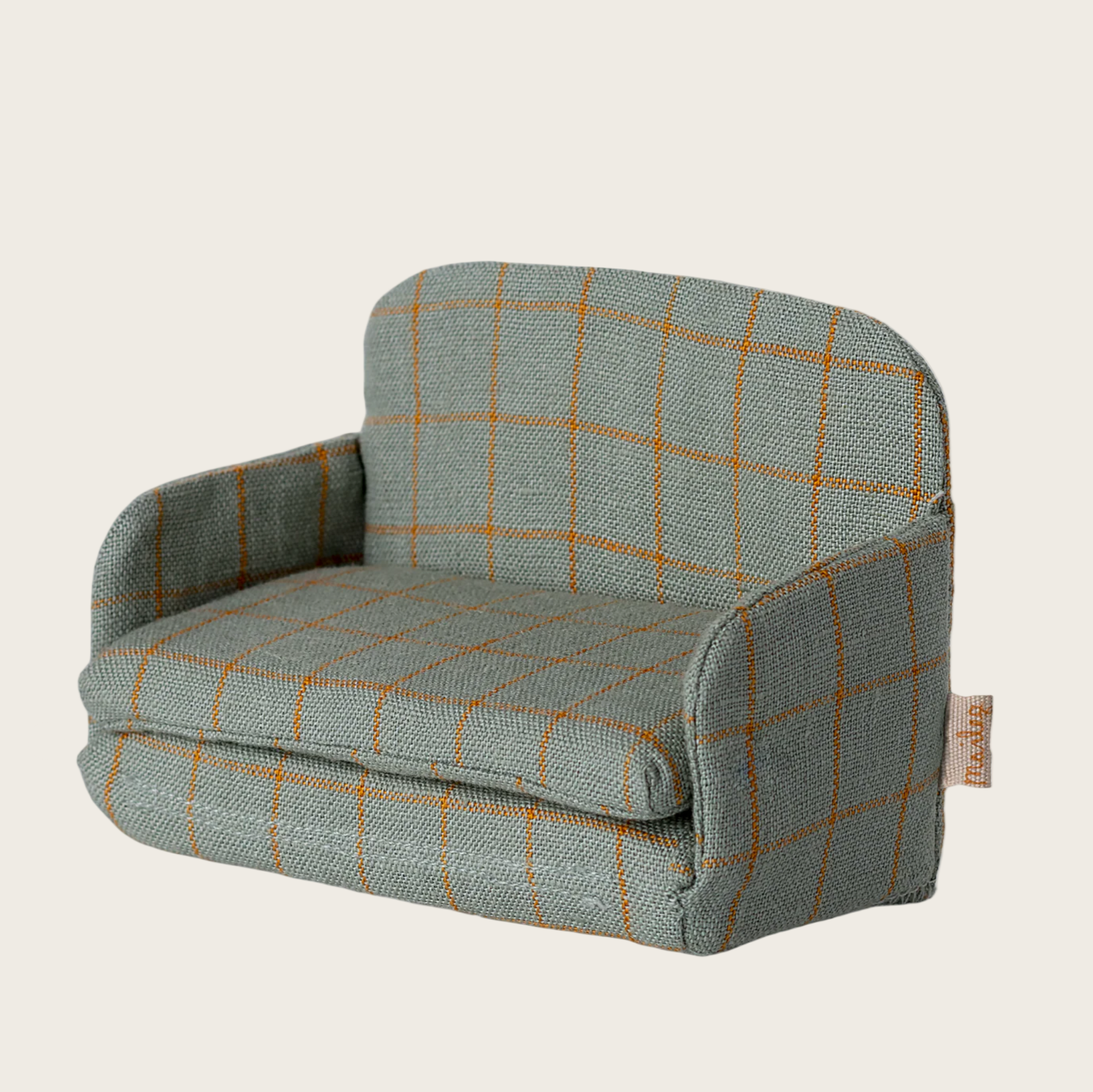 Plaid-patterned armchair on a beige background