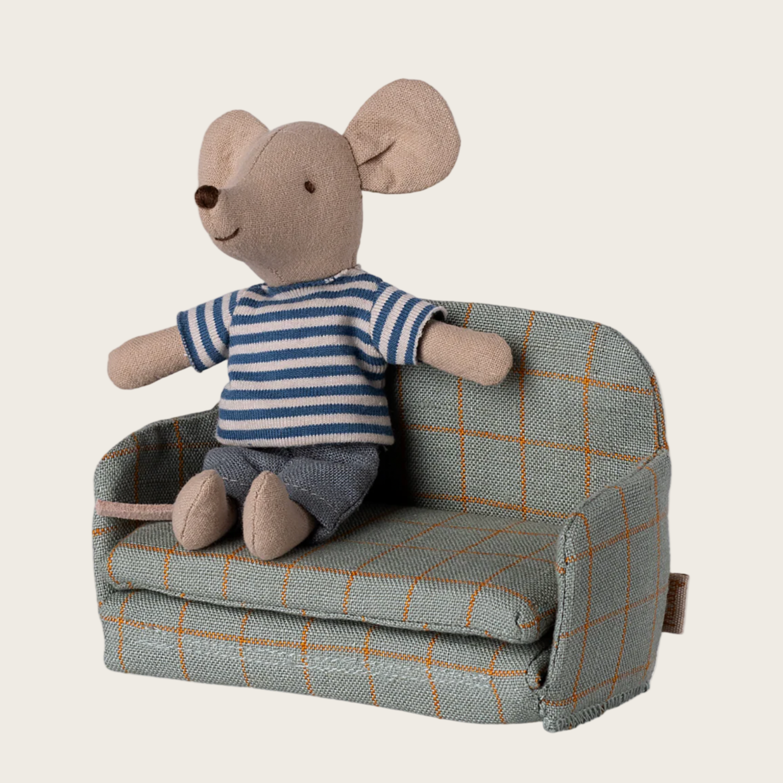 Stuffed toy mouse in a striped shirt sitting on a small plaid sofa