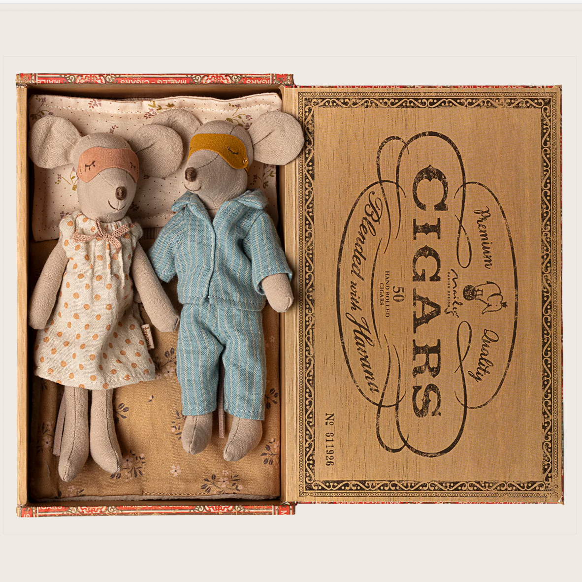 Two small stuffed animals in a box labeled 'Cigars'.