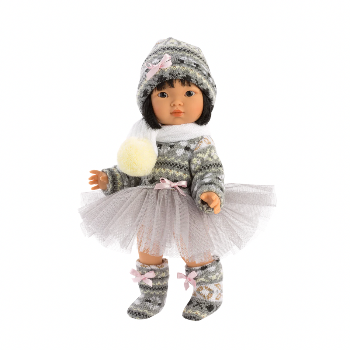 Doll in winter outfit with hat, scarf, and boots on a white background